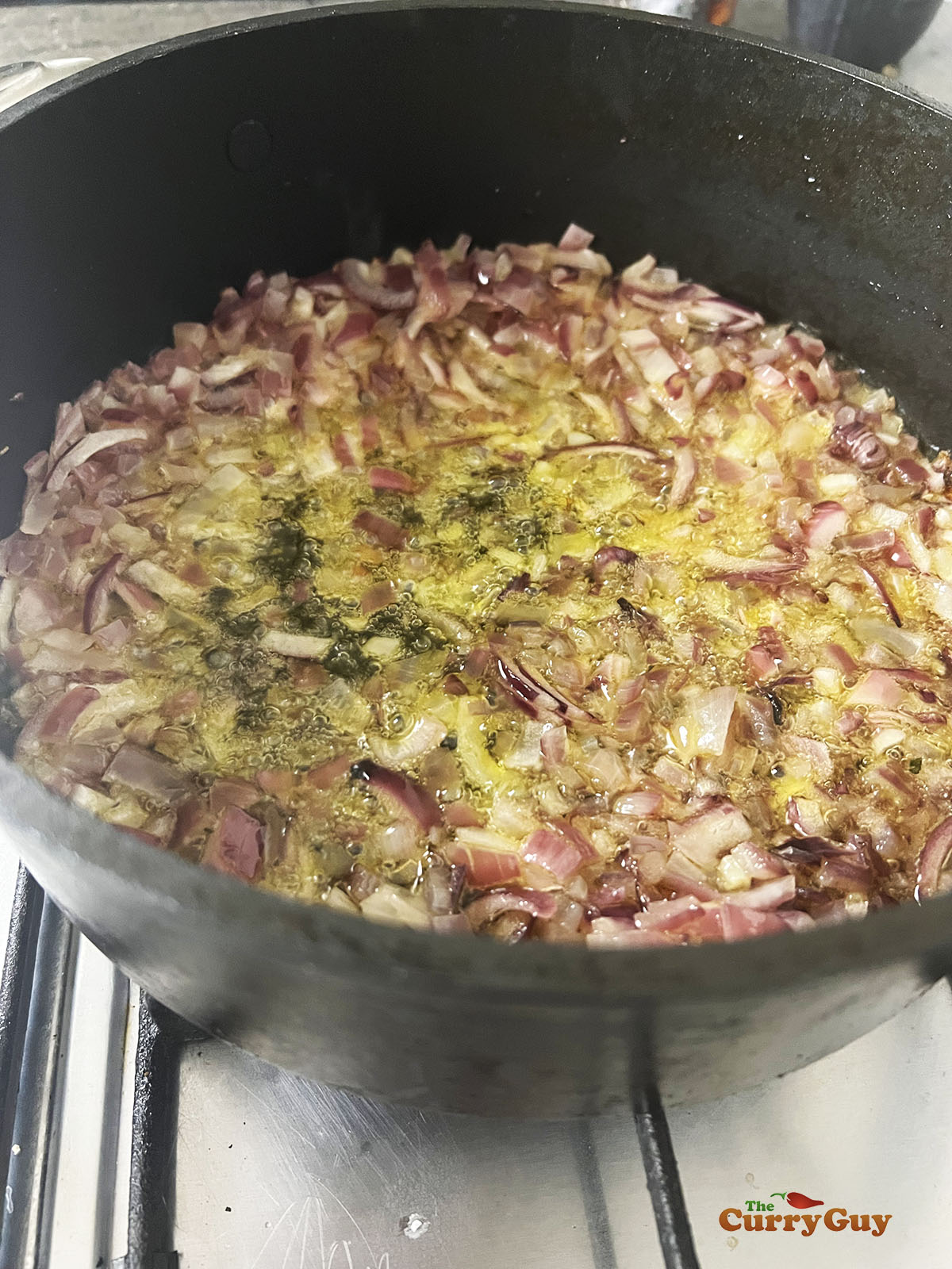 Frying the onions in ghee.