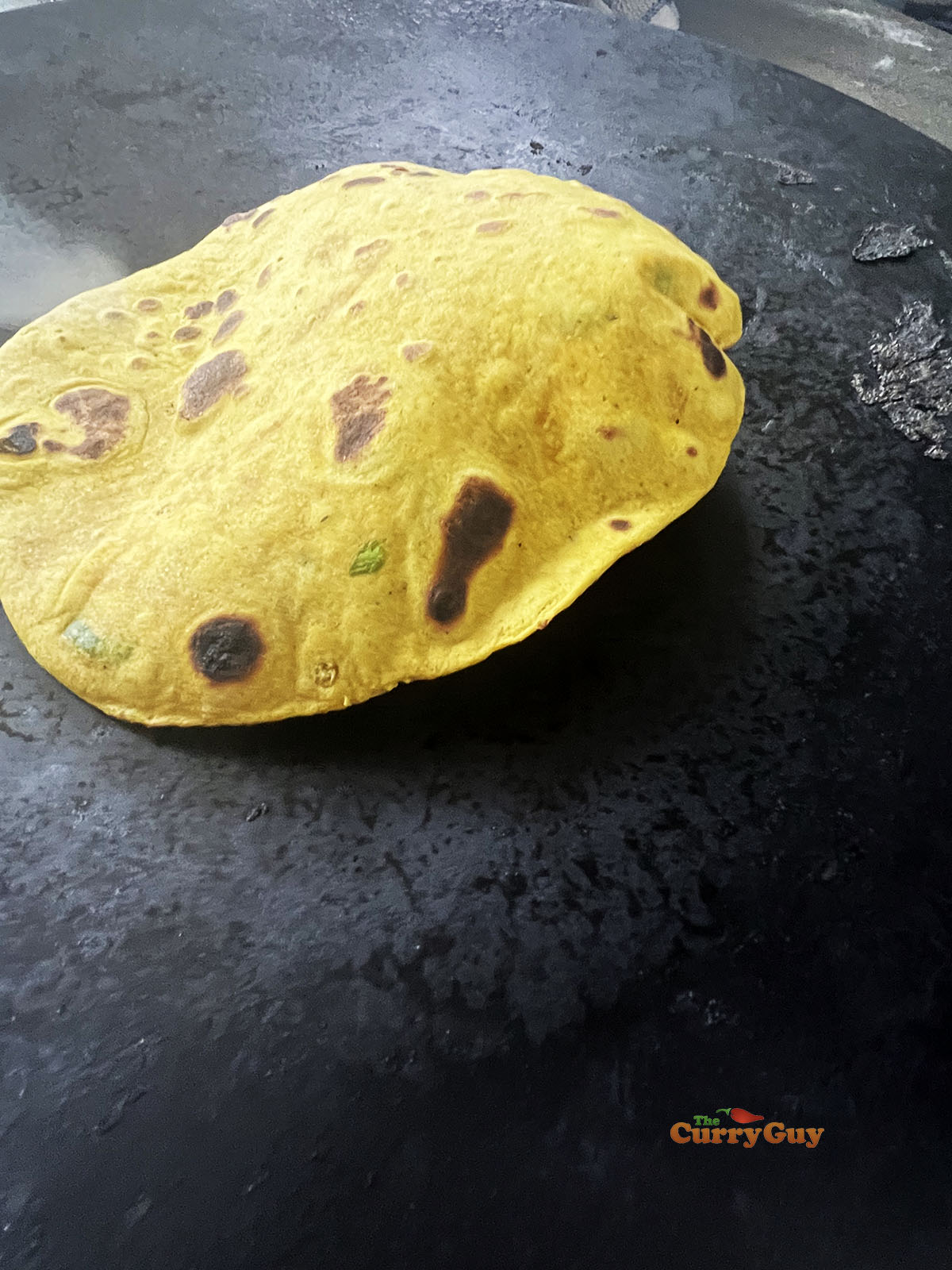 Chapati puffing up over the heat.