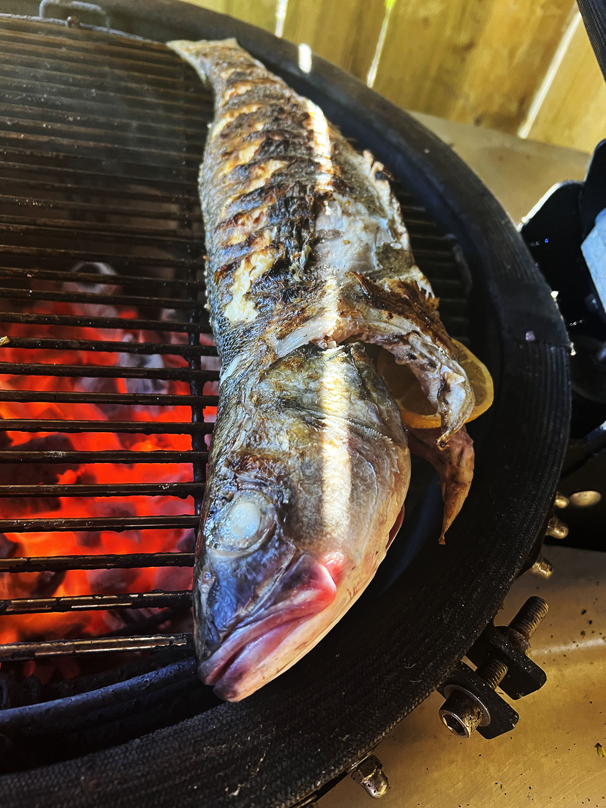 Turning the tandoori fish.