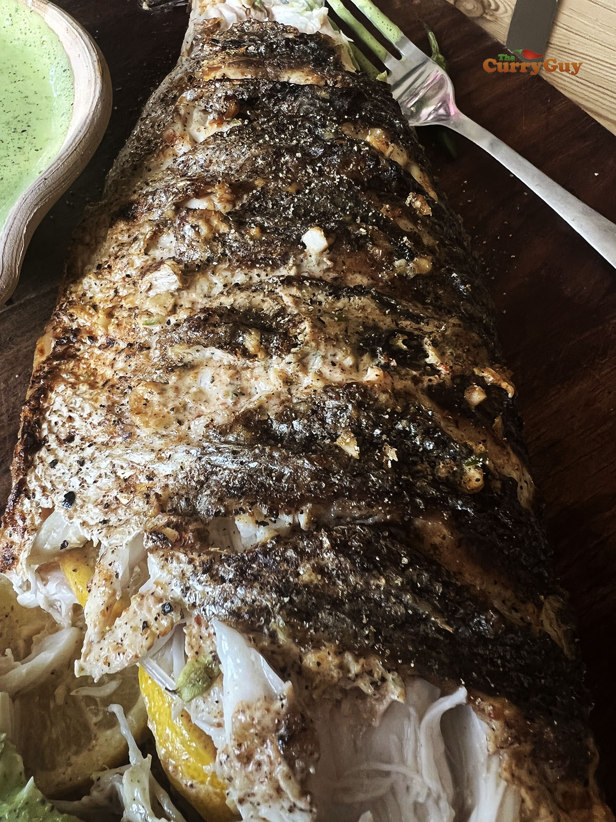 The charred skin of the tandoori fish.