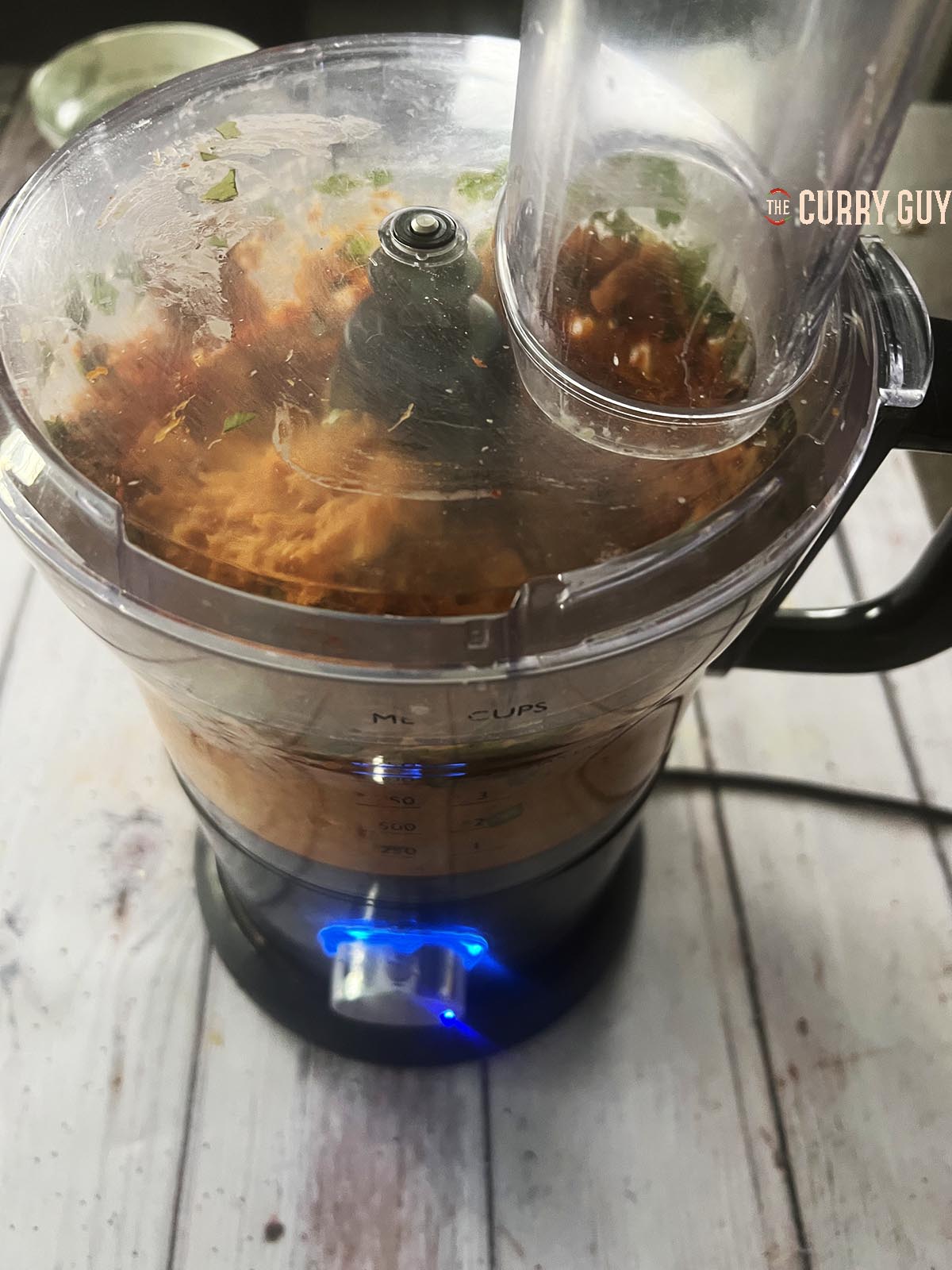 Blending the fish and aromatic ingredients in a food processor.