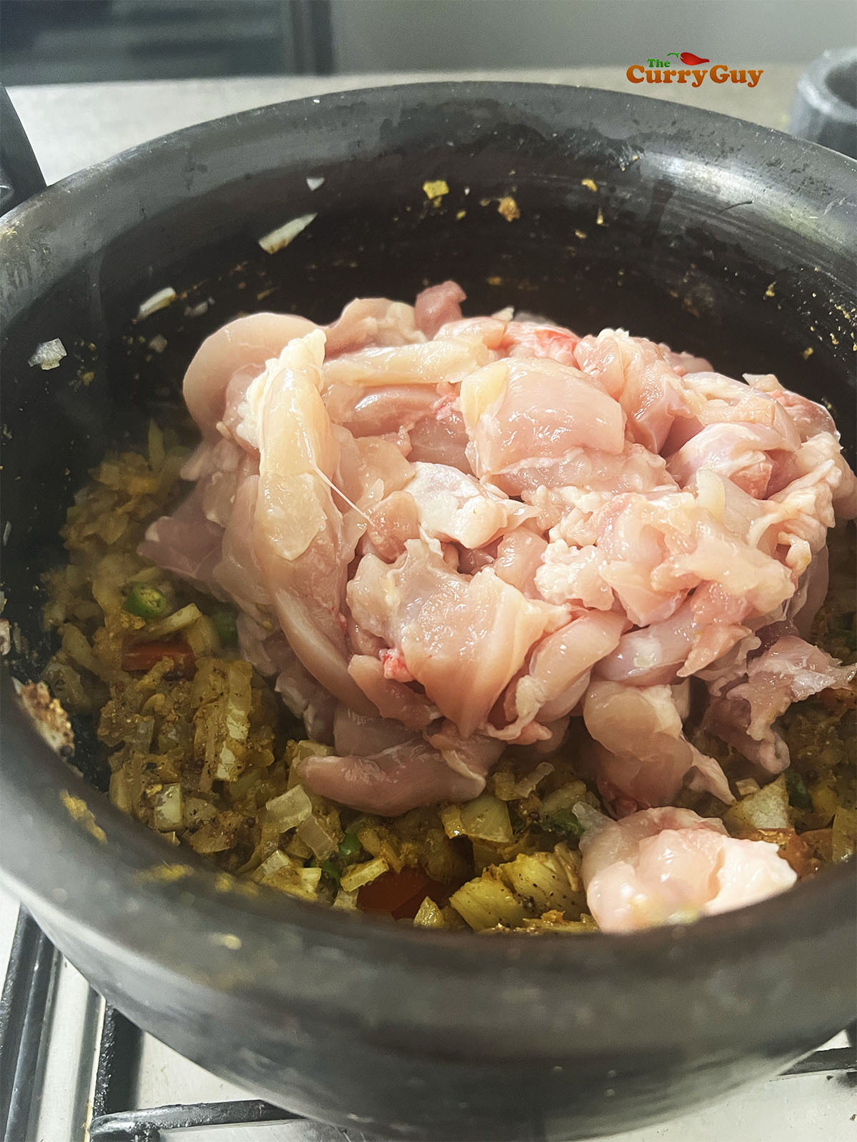 Adding the chicken to the pot.
