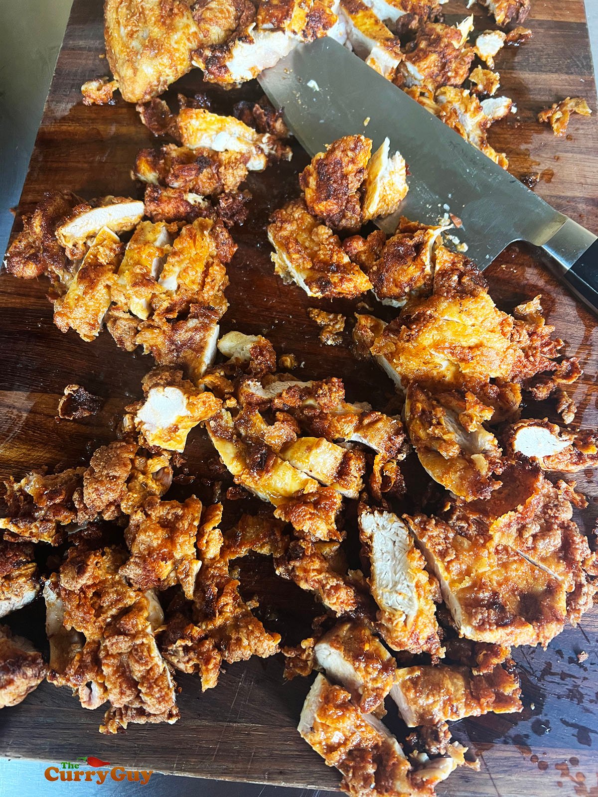 Fried chicken cut into bite sized pieces.