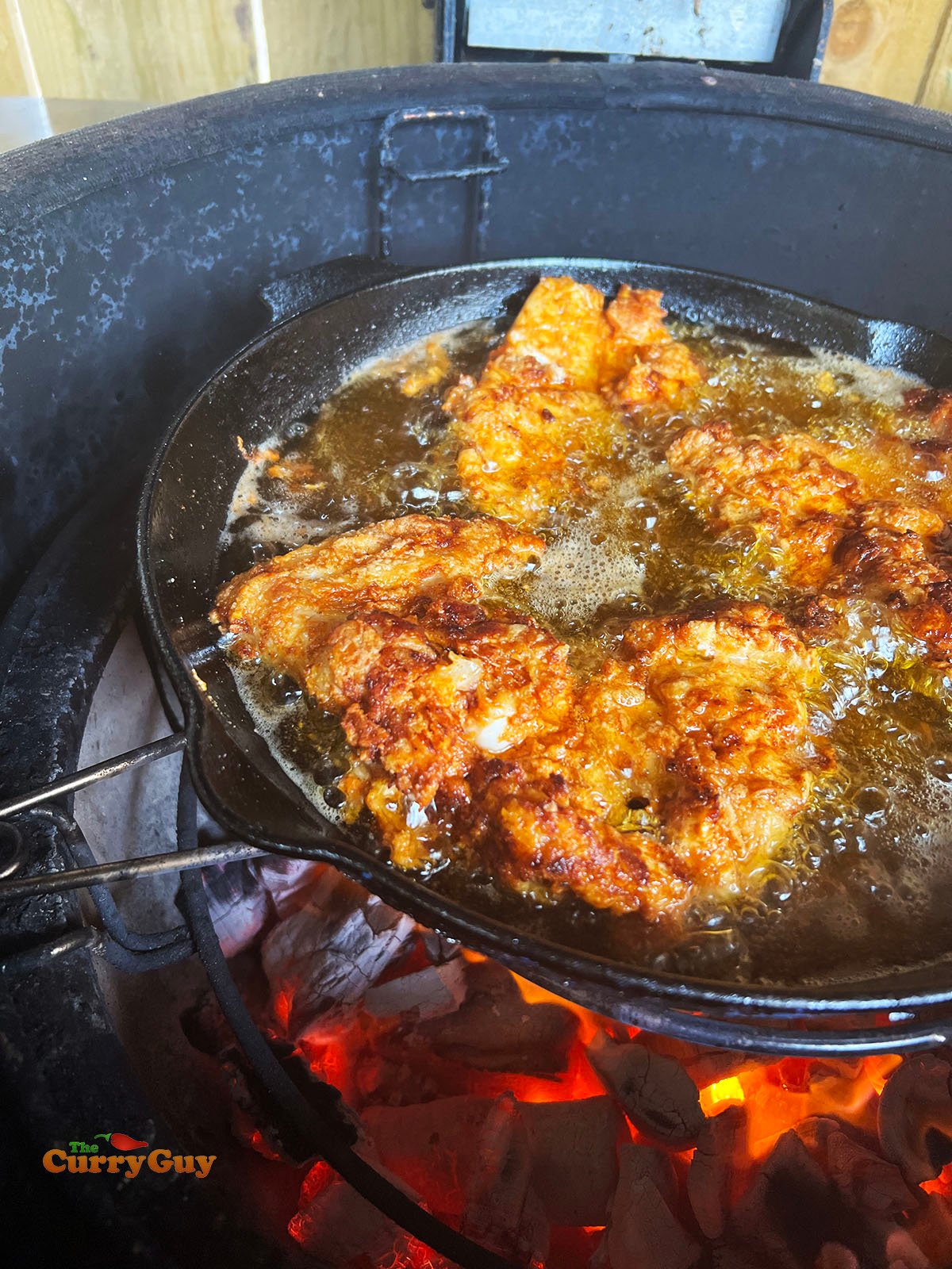 Frying the flour dusted chicken pieces