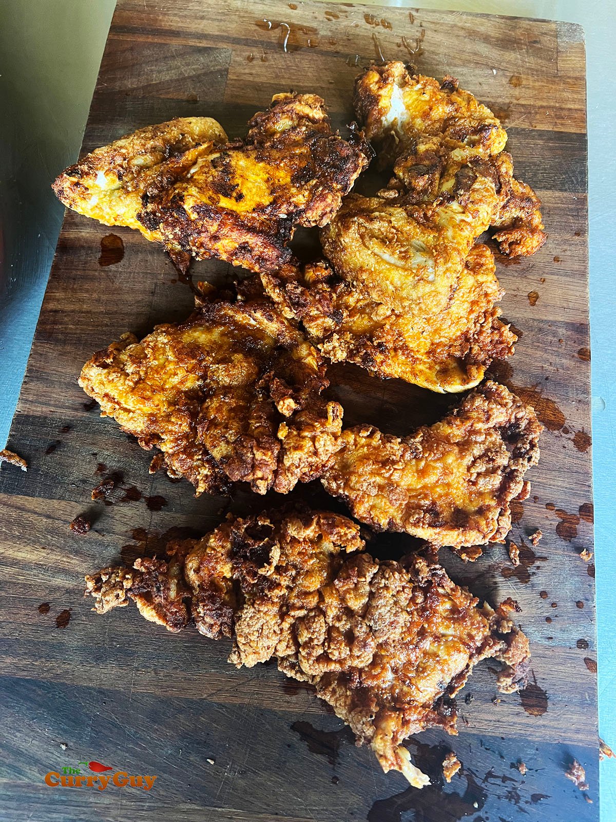 Crispy fried chicken ready for cutting.