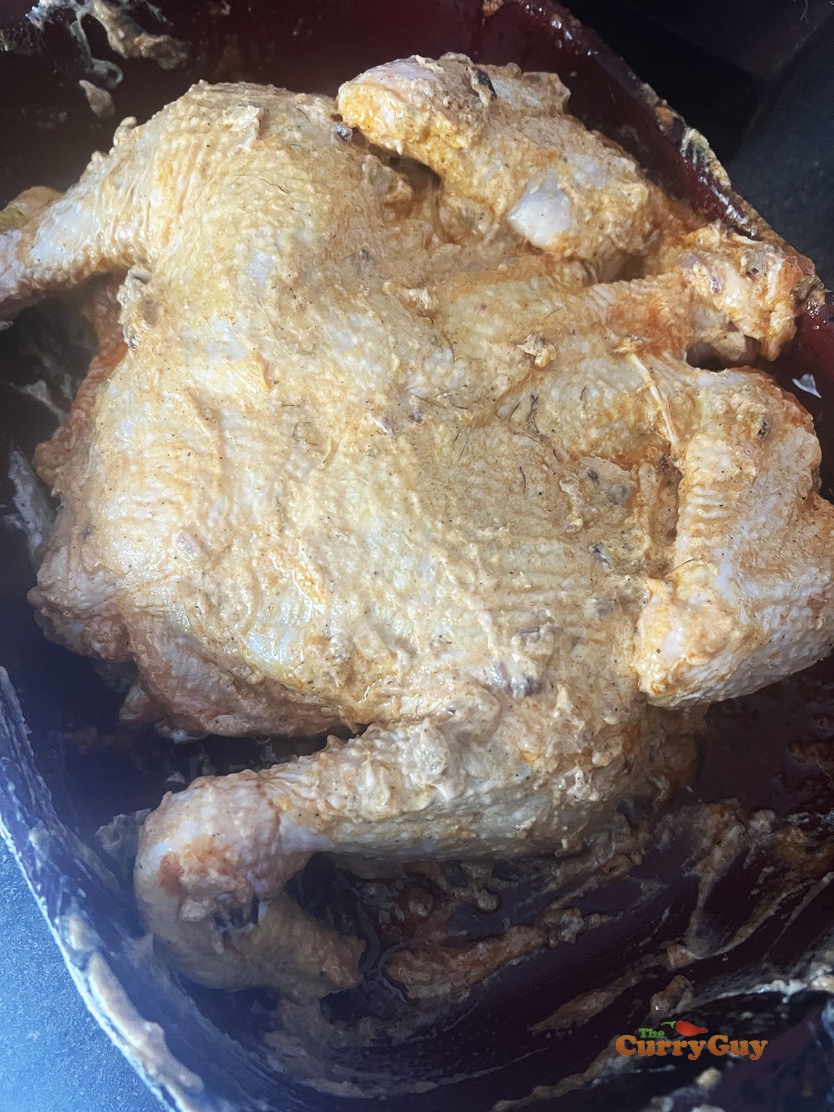 Applying the marinade to the chicken.