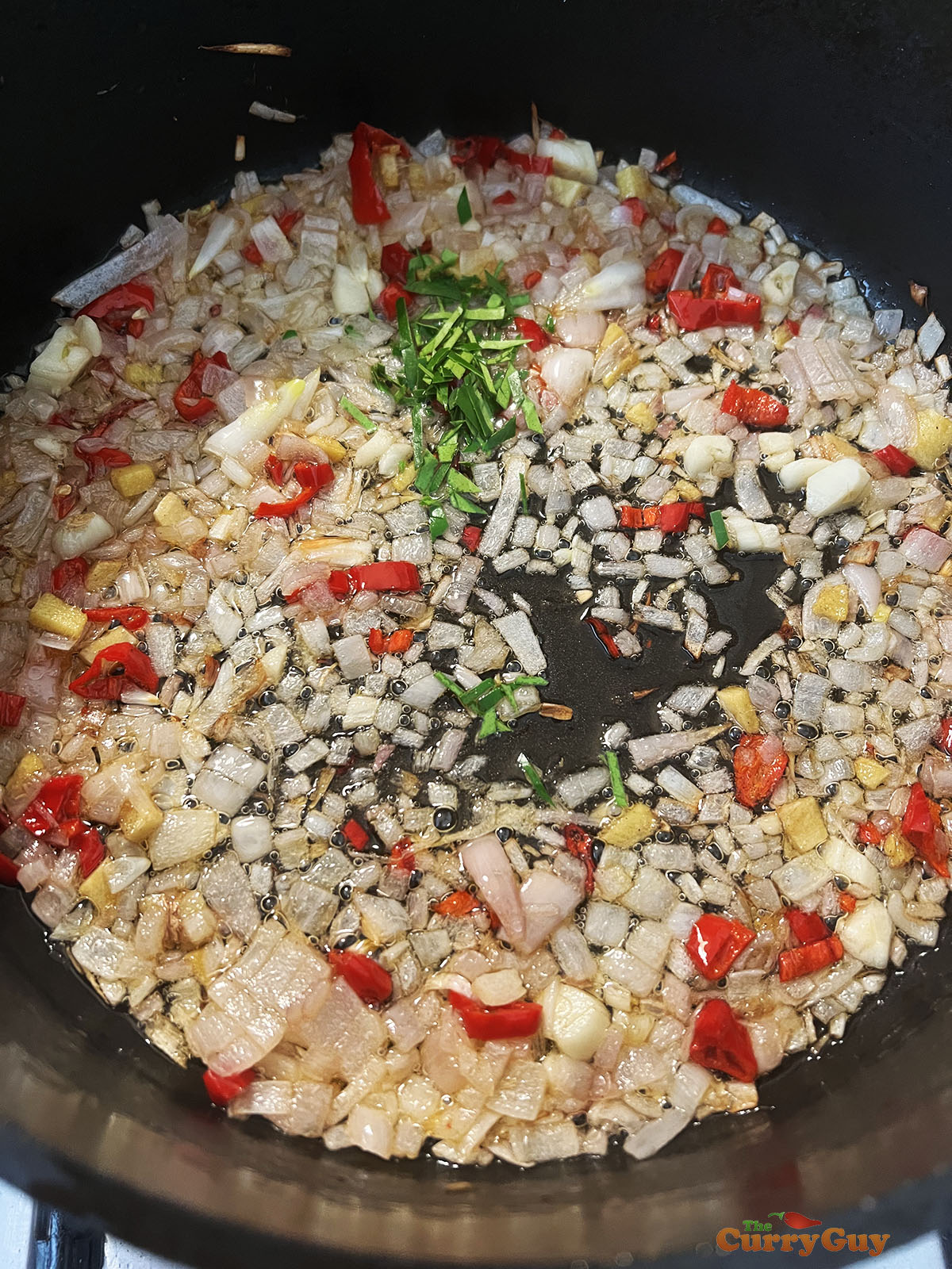Frying shallots, garlic, ginger and chillies. 
