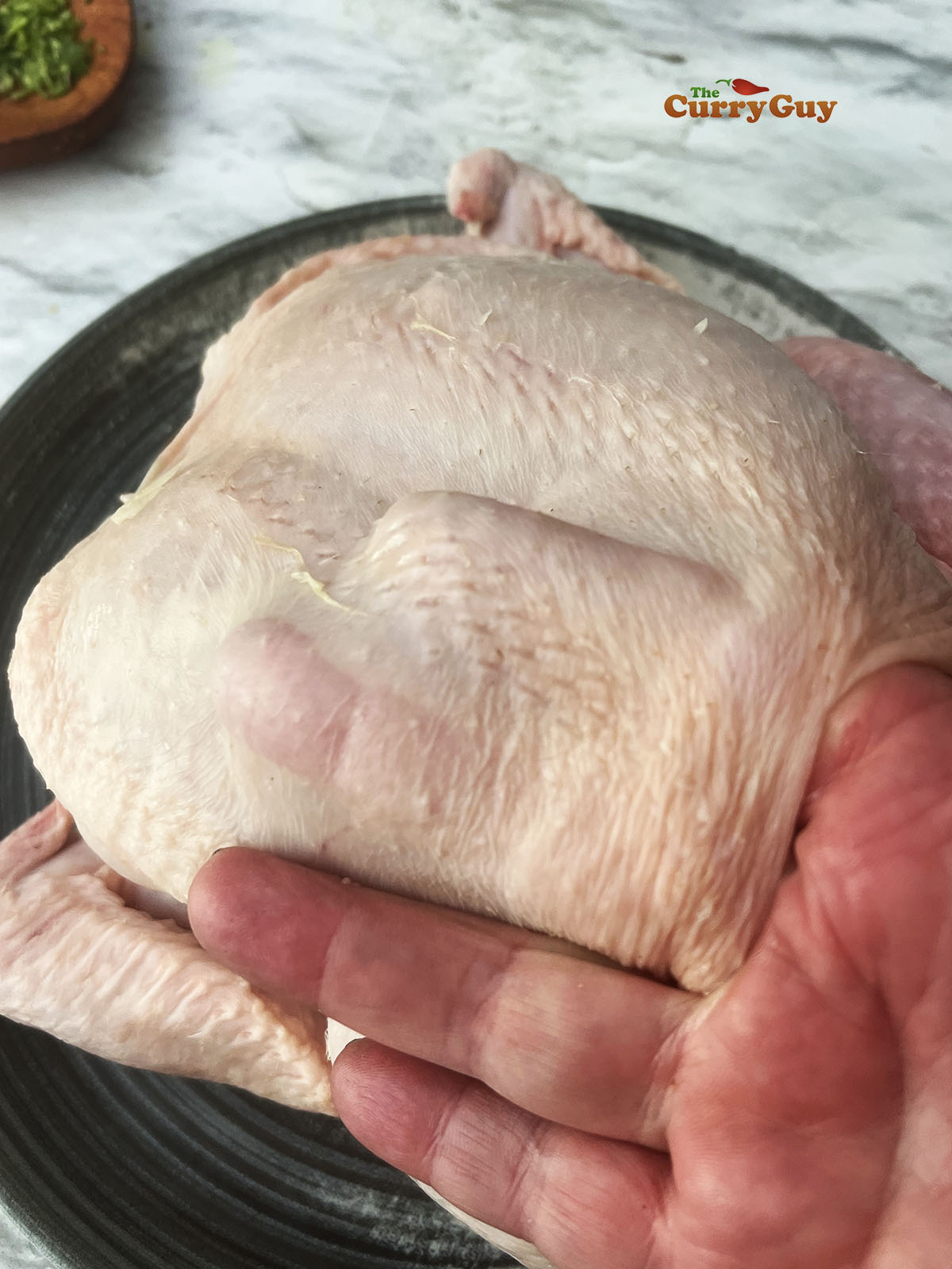 Separating the chicken skin from the meat.
