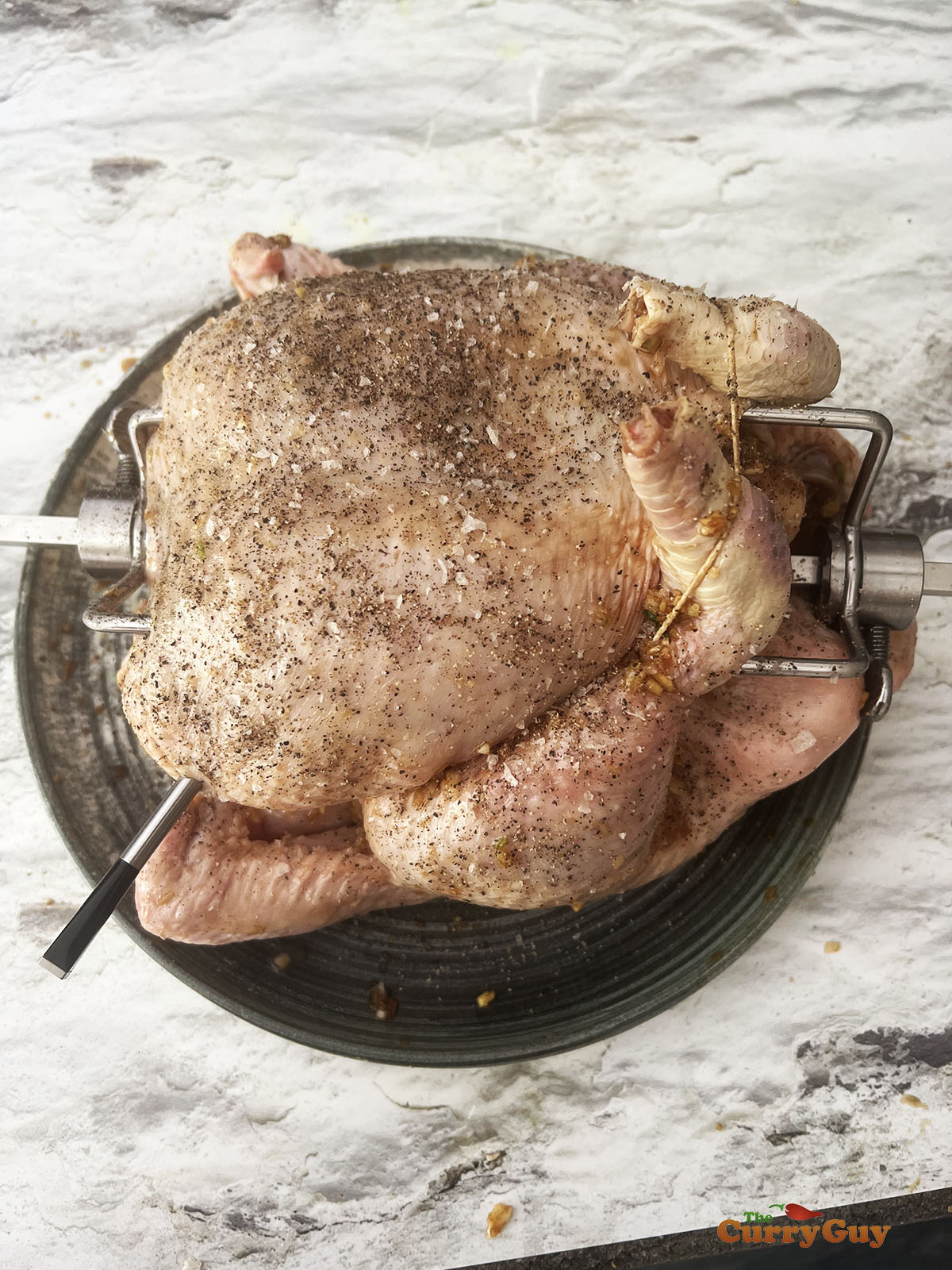 Chicken covered in goose fat and seasoned with salt and pepper. 