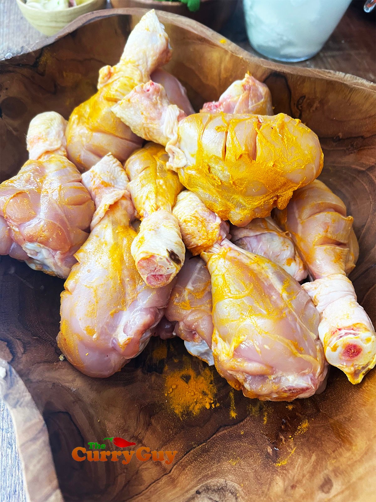 Chicken drumsticks coated with ground turmeric.