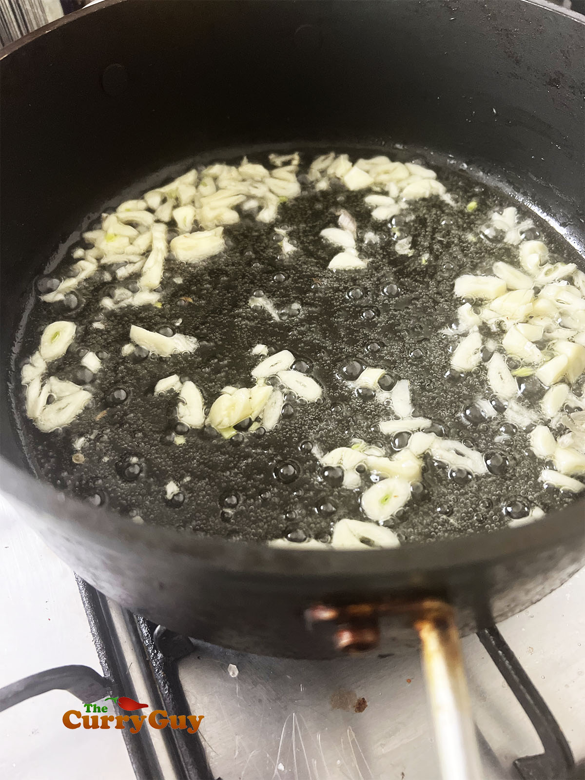 Frying garlic slivers in oil. 