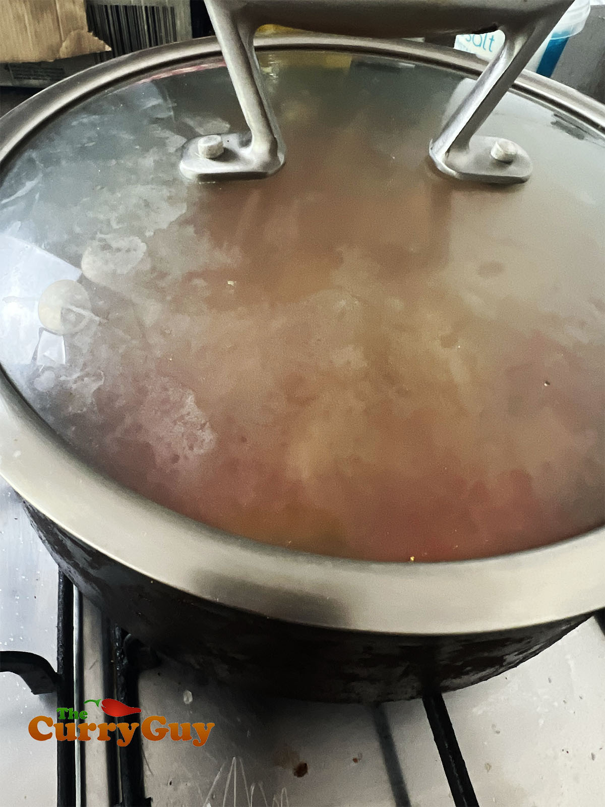 Simmering the curry in a covered pan.