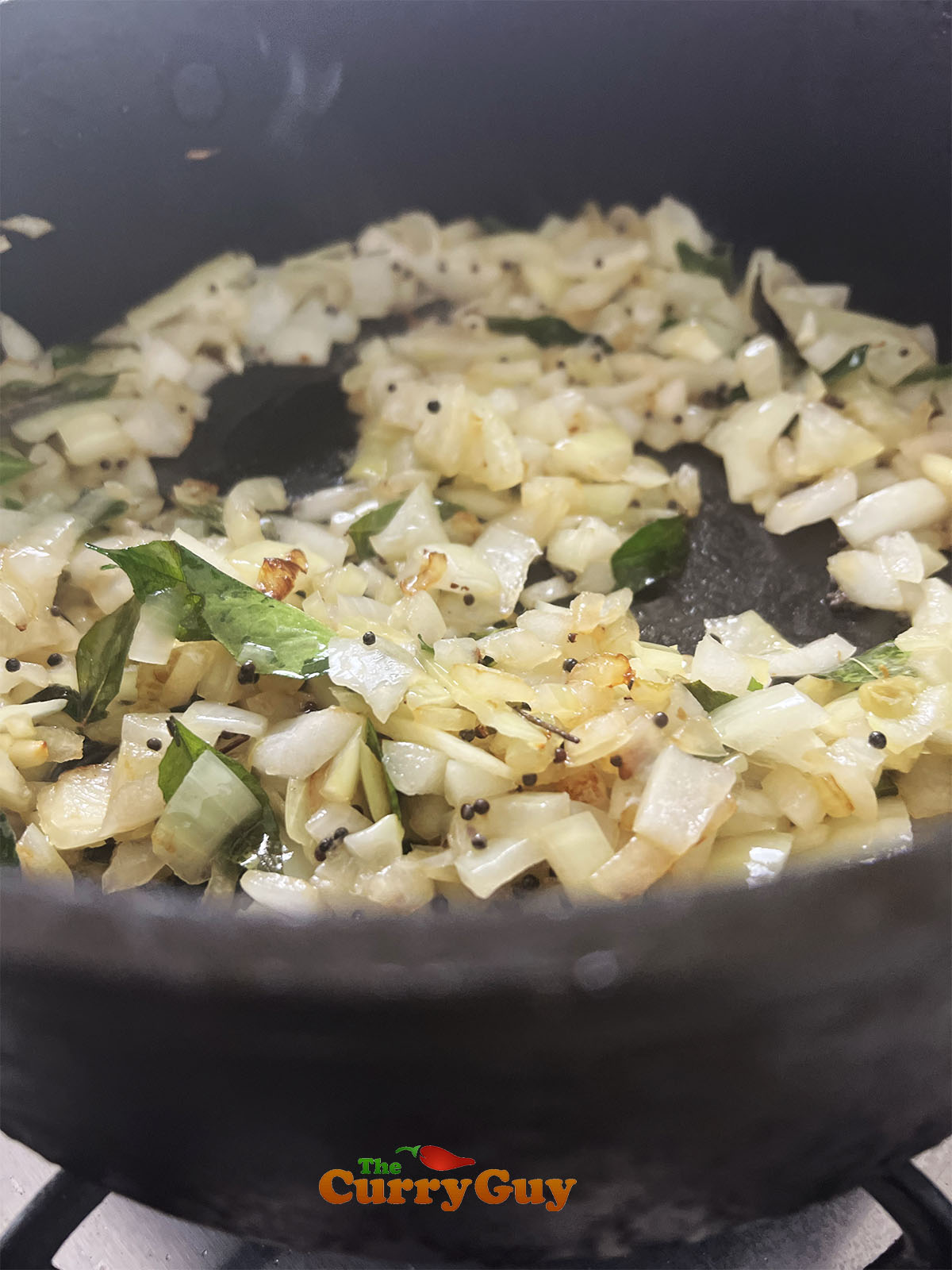 Adding and frying the onions in the pan.