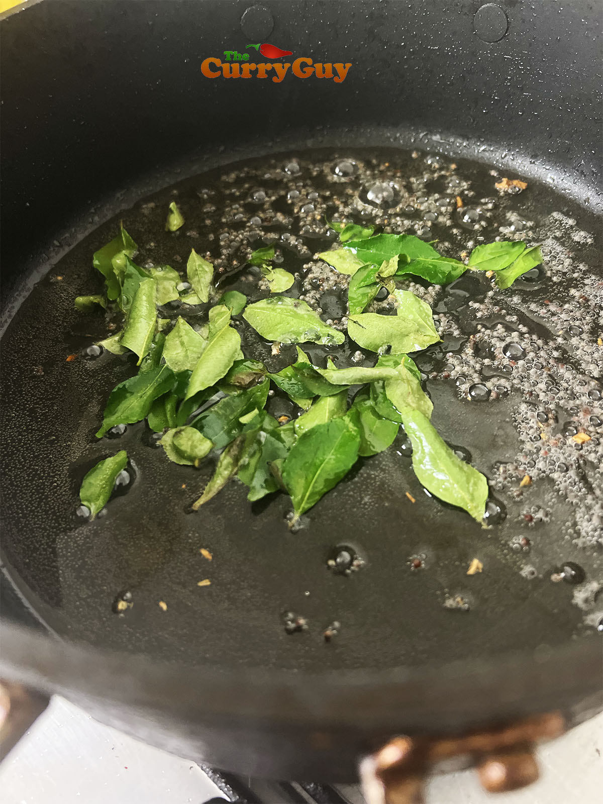 Infusing the flavours of mustard seeds and curry leaves into the oil.