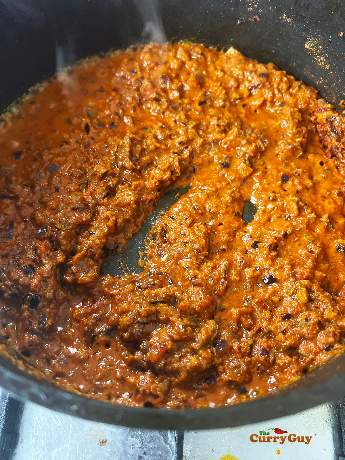 Water added to the spices so that they don't burn.