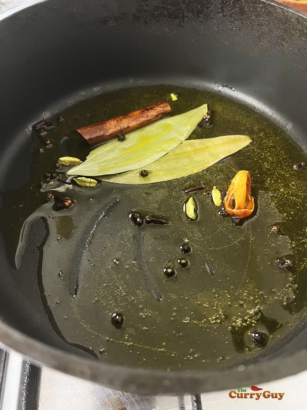 Infusing whole spices in oil.