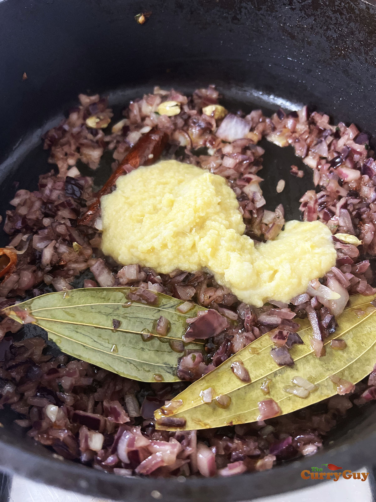 Frying onions, garlic and ginger in the flavoured spice oil.