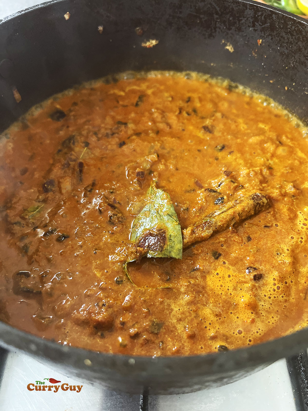 Adding water to the pan so that the spices don't burn.