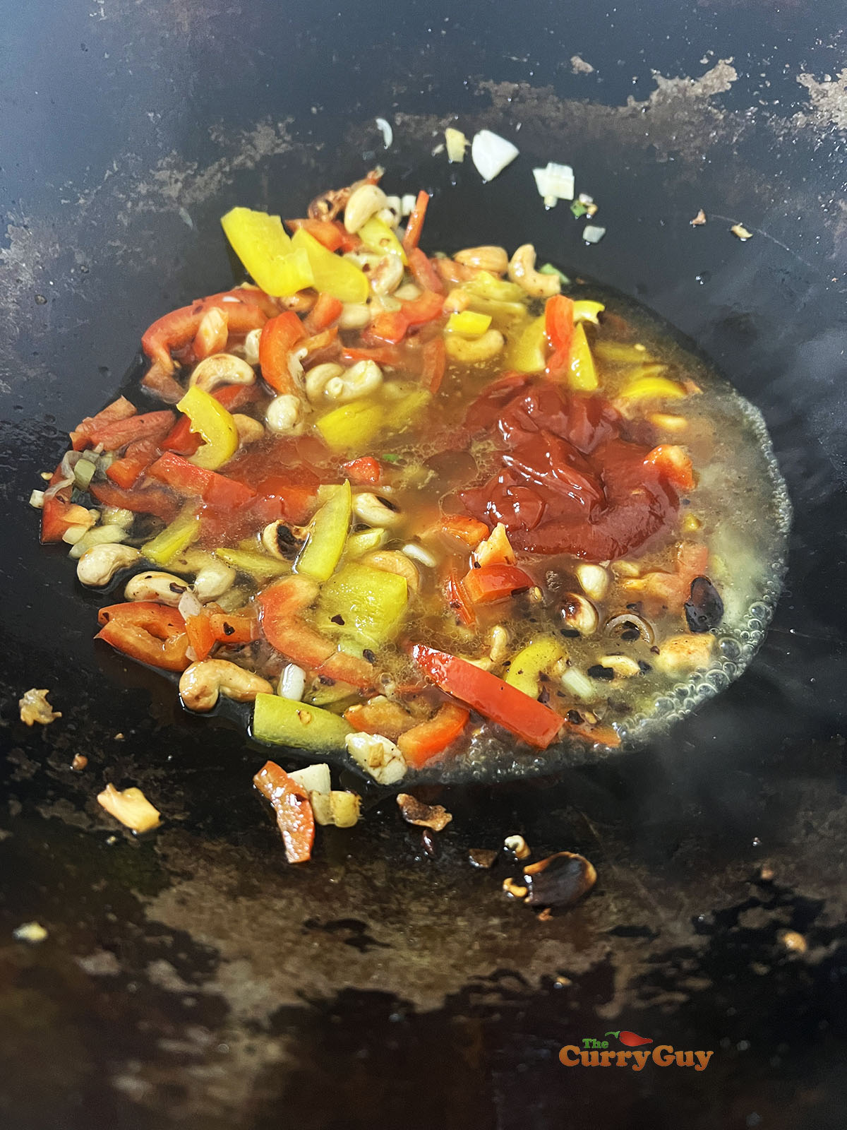 Adding the onion, bell pepper and sauce ingredients.
