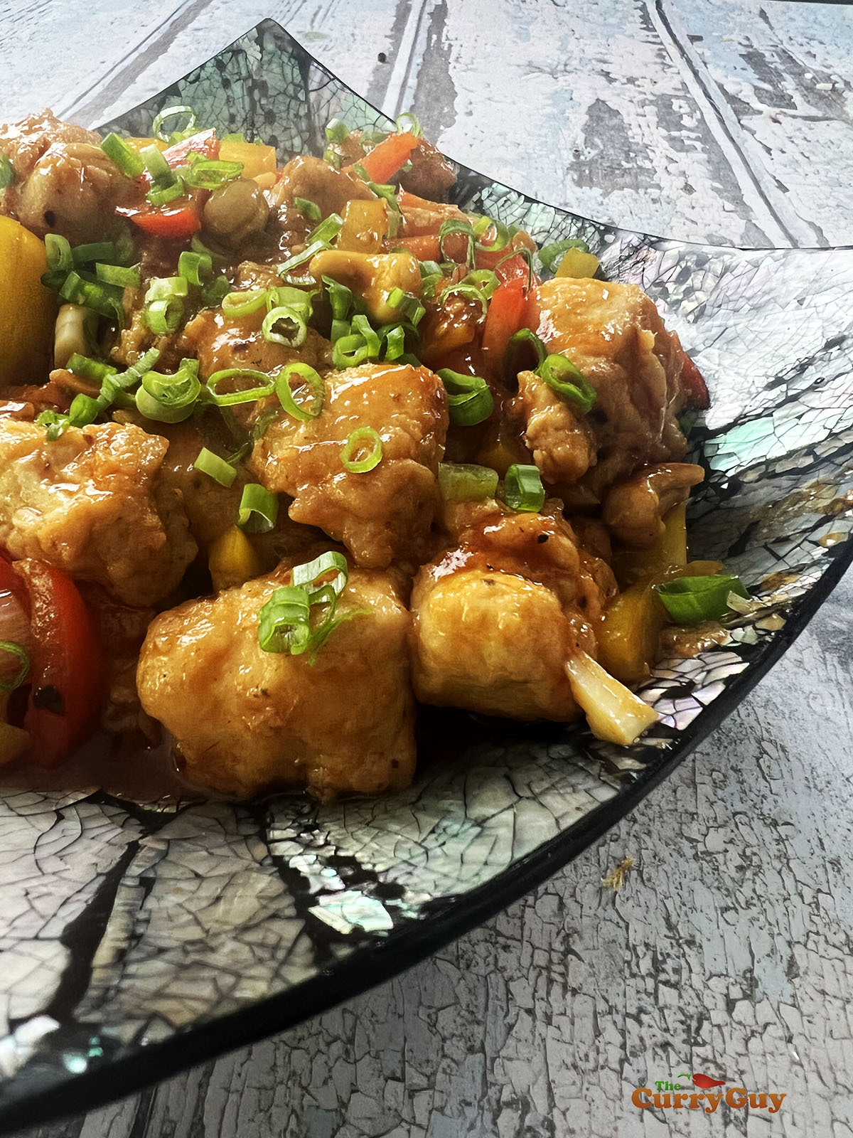 Finished dragon chicken, garnished with coriander (cilantro) and chillies.