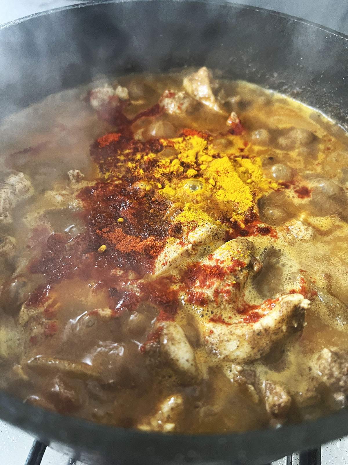 Simmering the sauce to thicken.