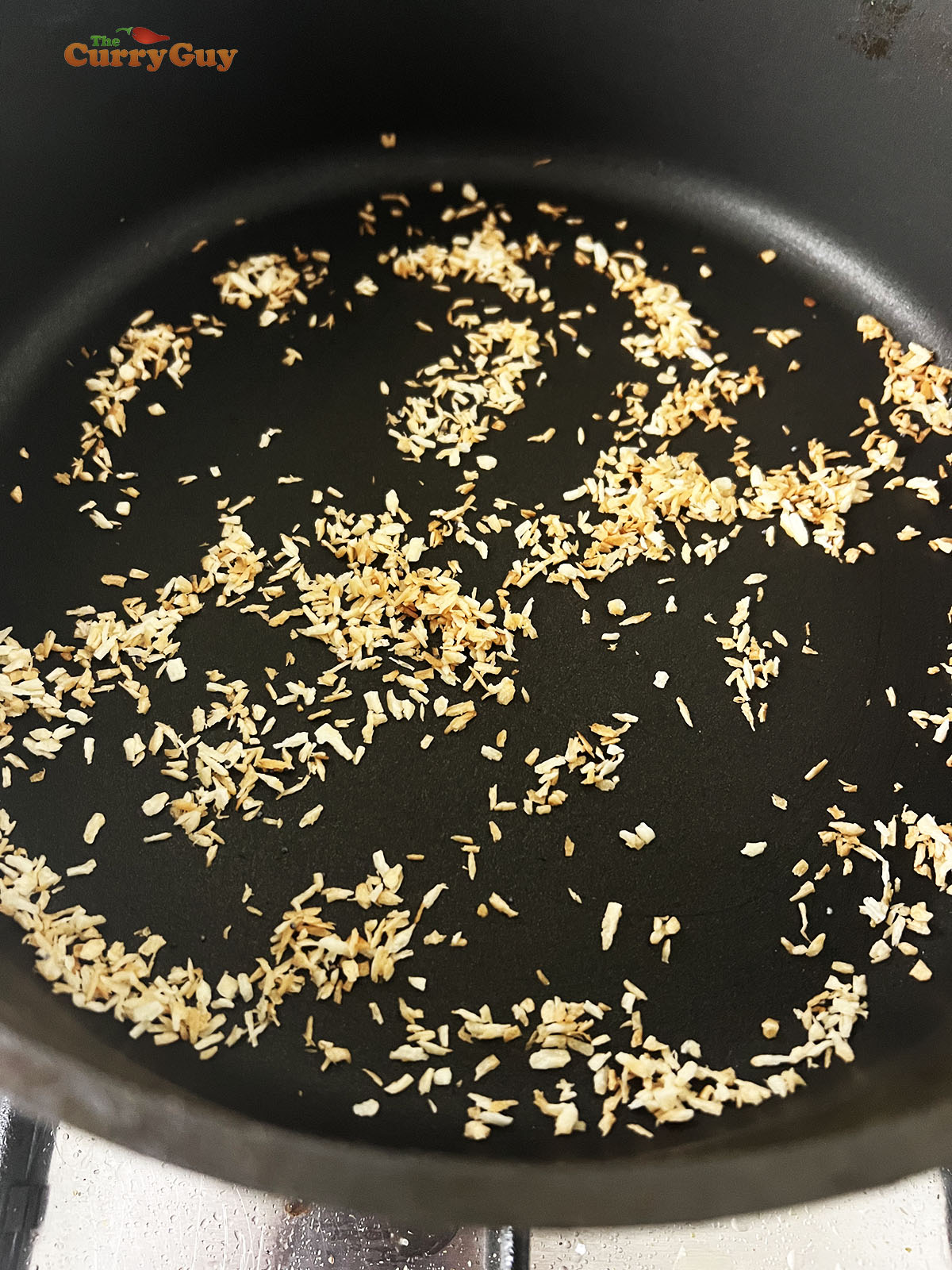 Toasting grated coconut.