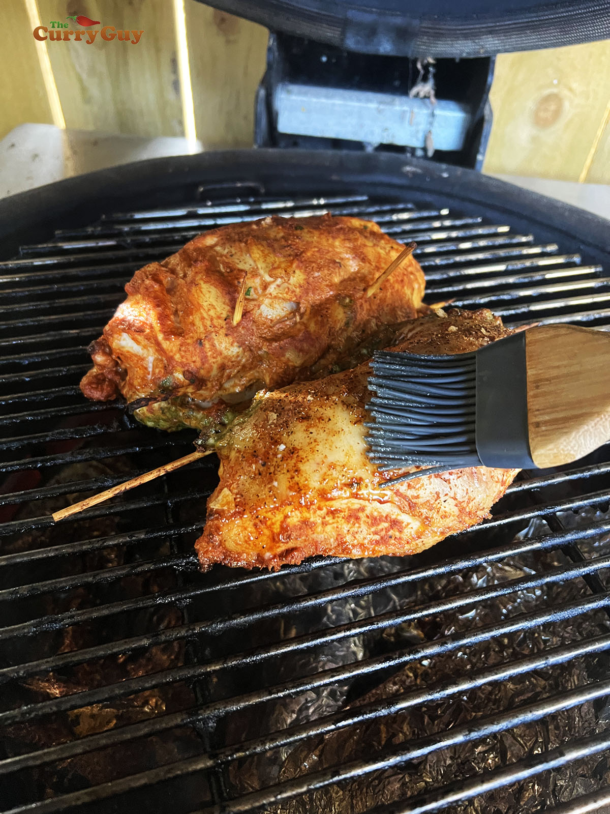 Basting the chicken with ghee.