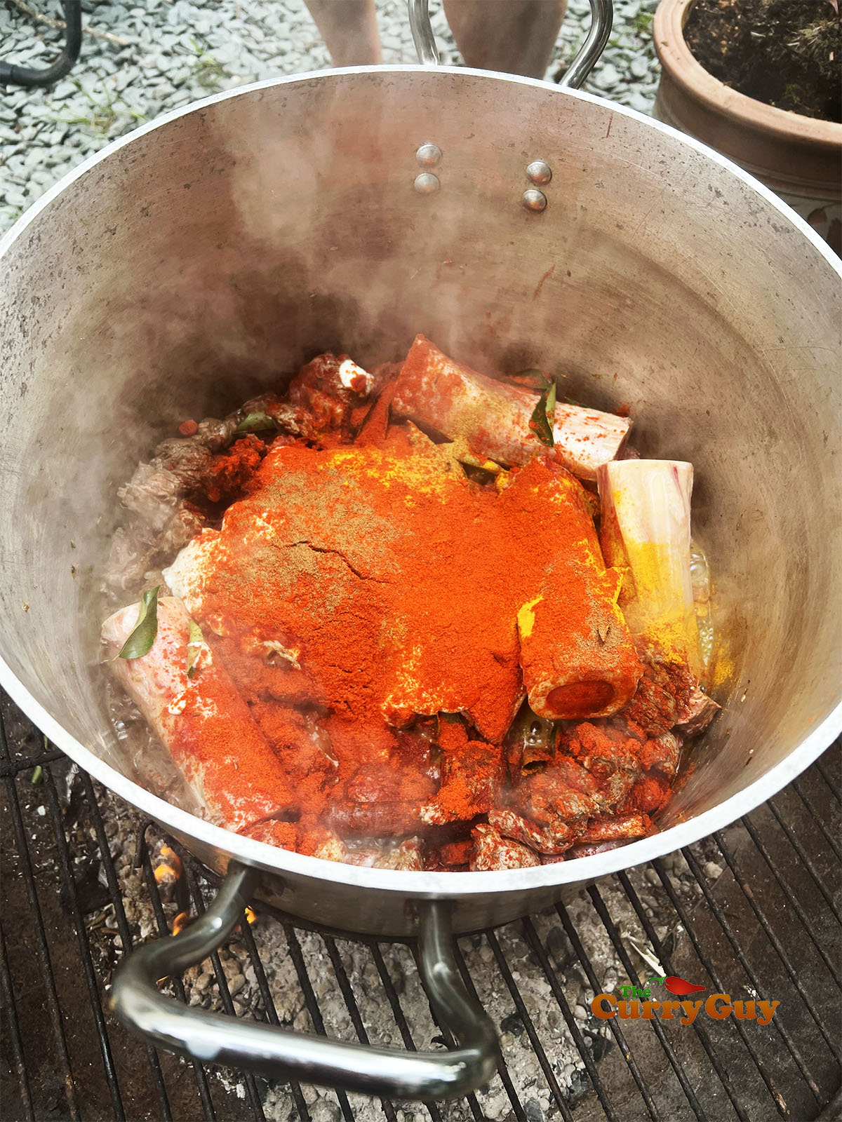 Adding the ground spices to the pot.