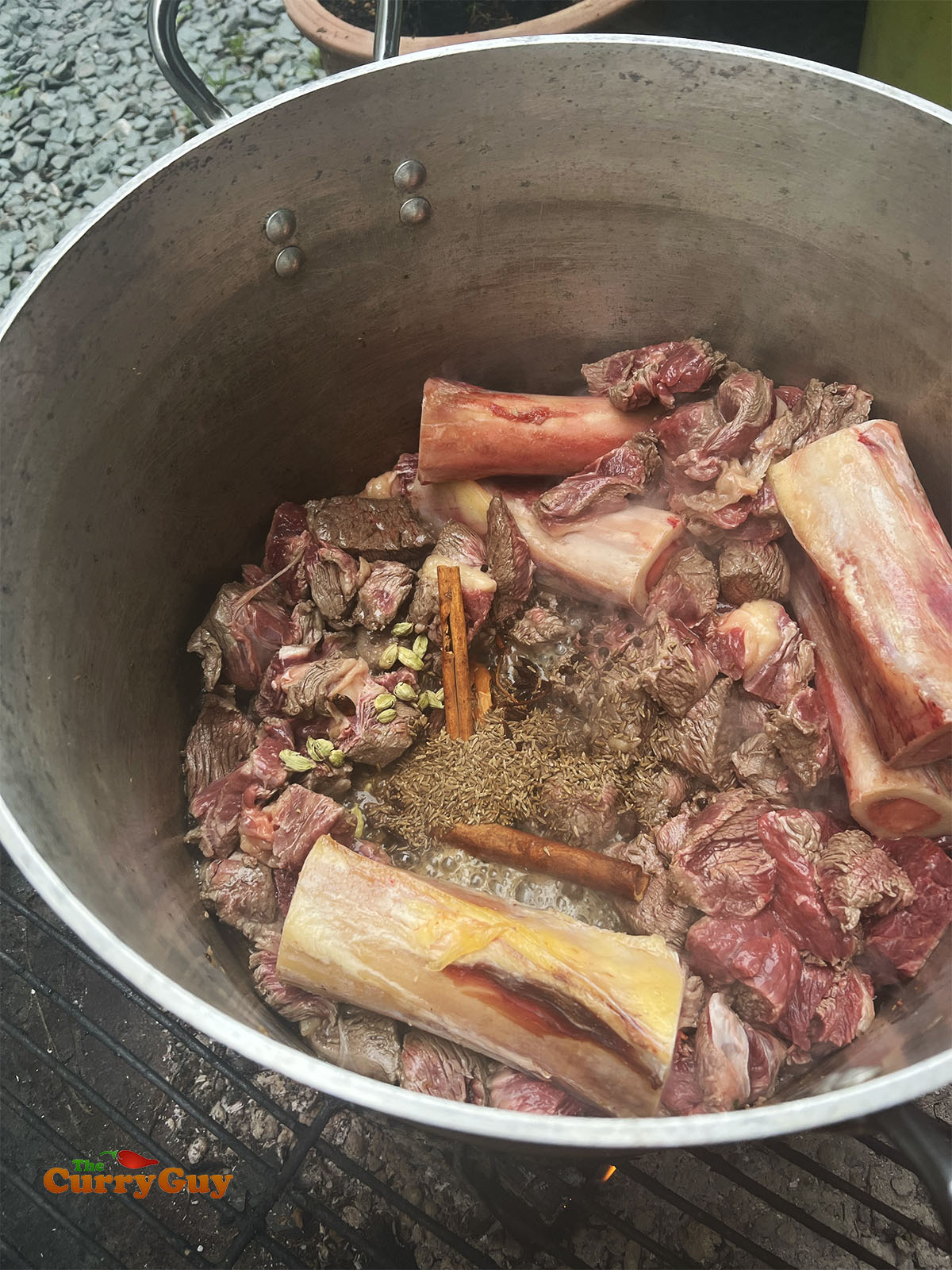 Frying the beef and beef bones with the whole spices.