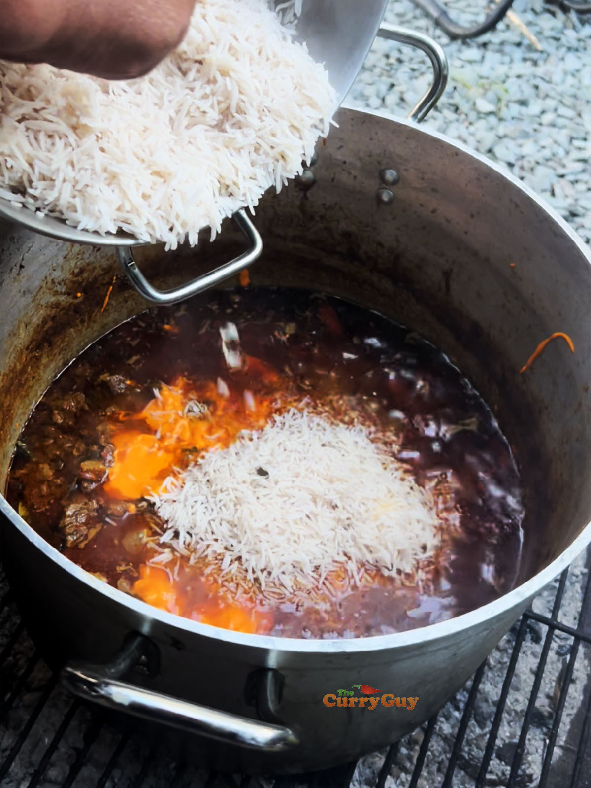 Adding rice to the stewing beef.
