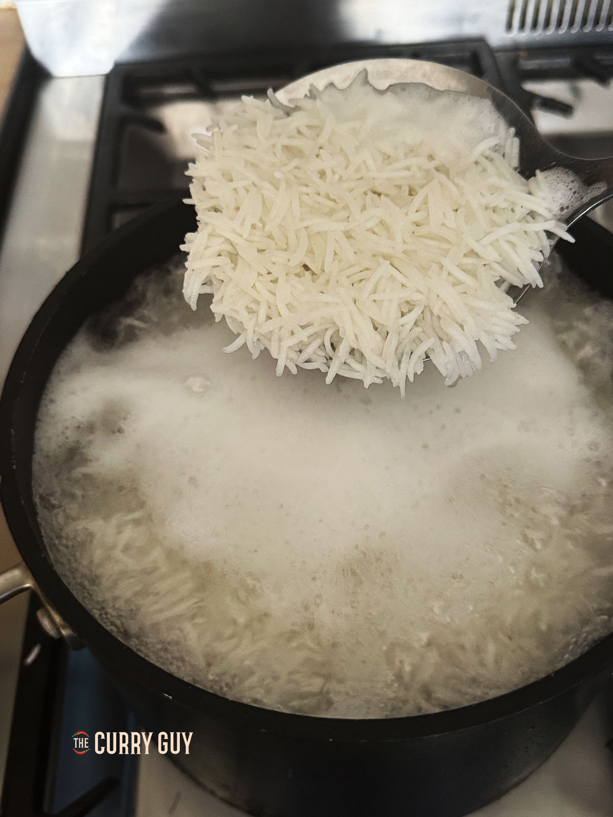 Transferring half the rice to a bowl after cooking for 6 minutes.