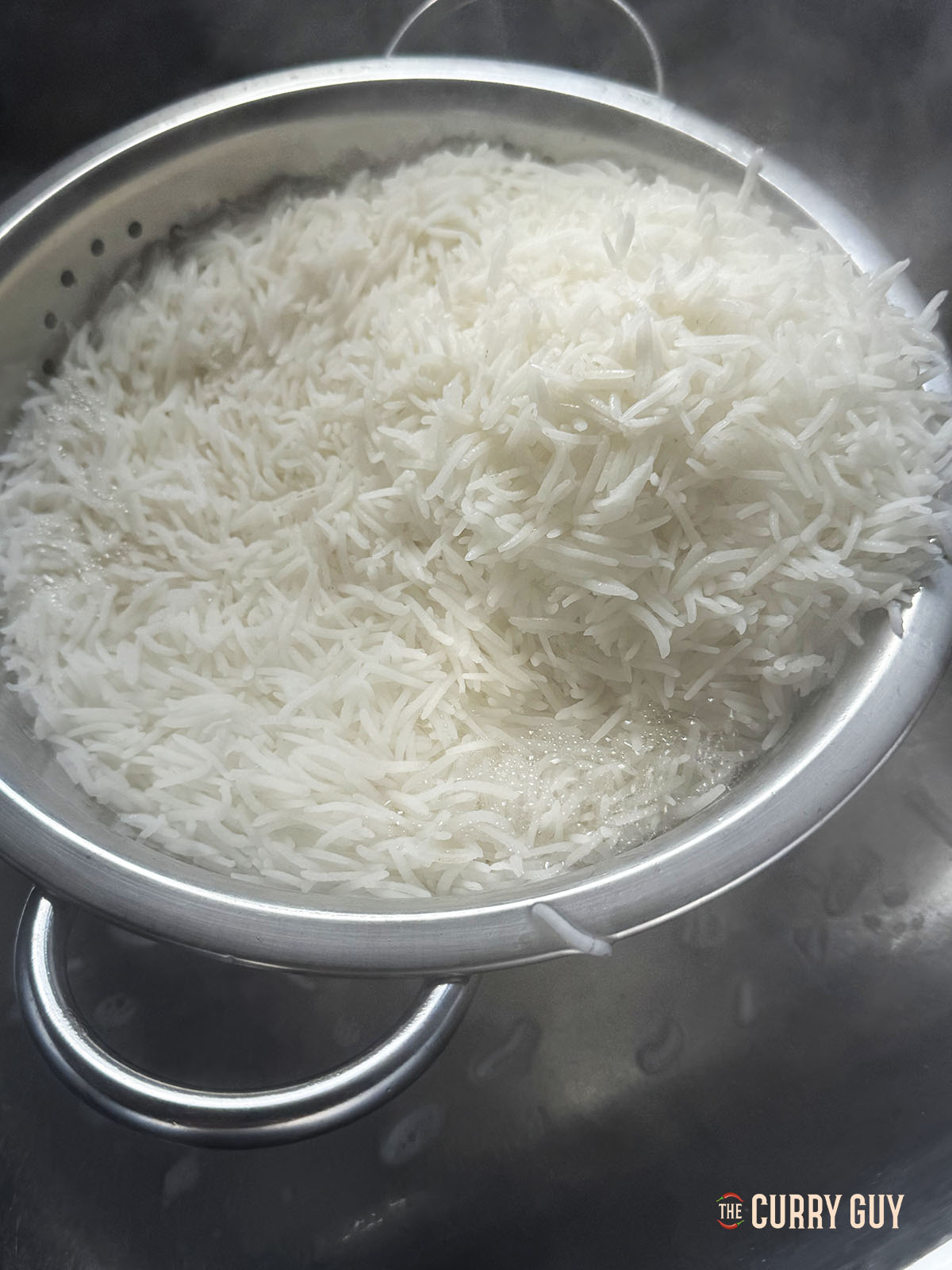 Straining the rice into a collander.