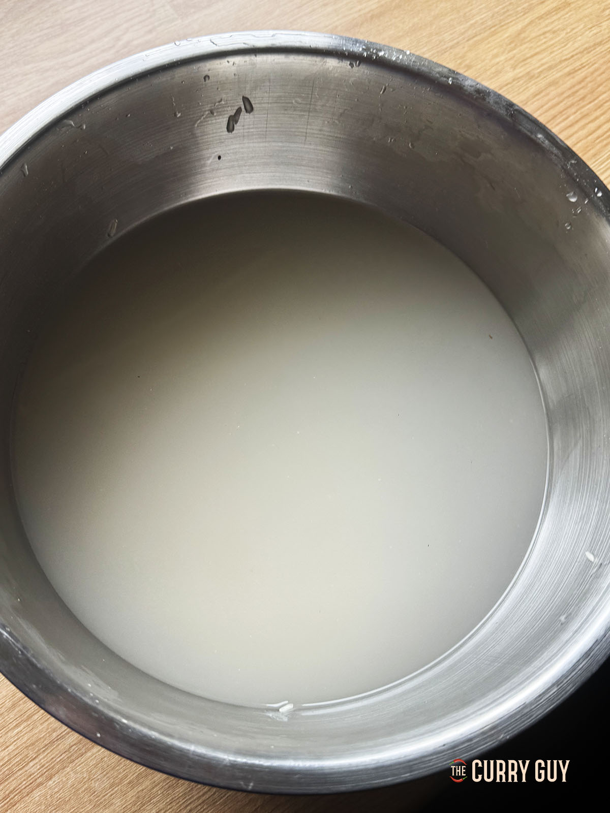 Washing Basmati rice in a bowl of water.