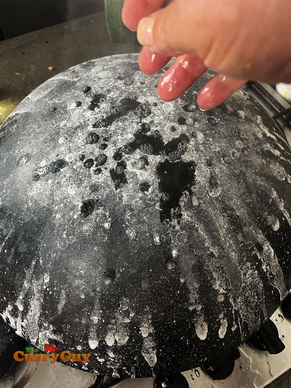 An upturned wok splashed with salt water. 