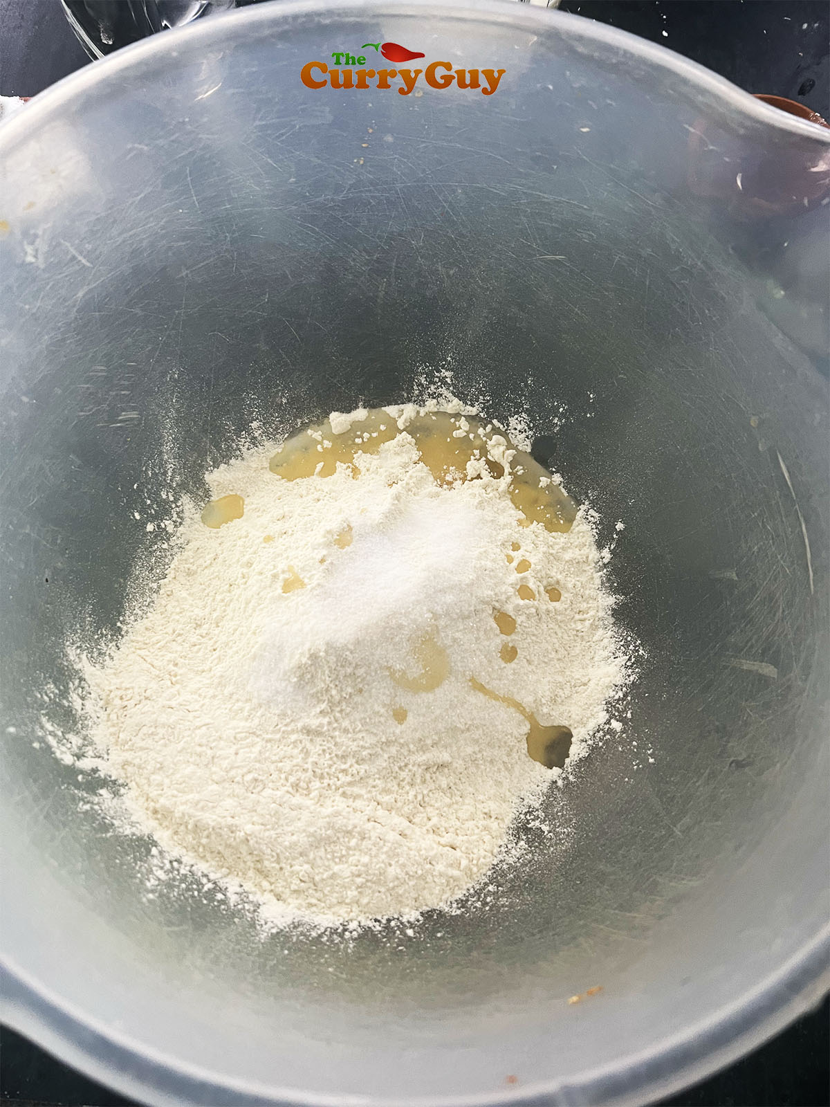 Flour, salt and sugar in a mixing bowl with oil.