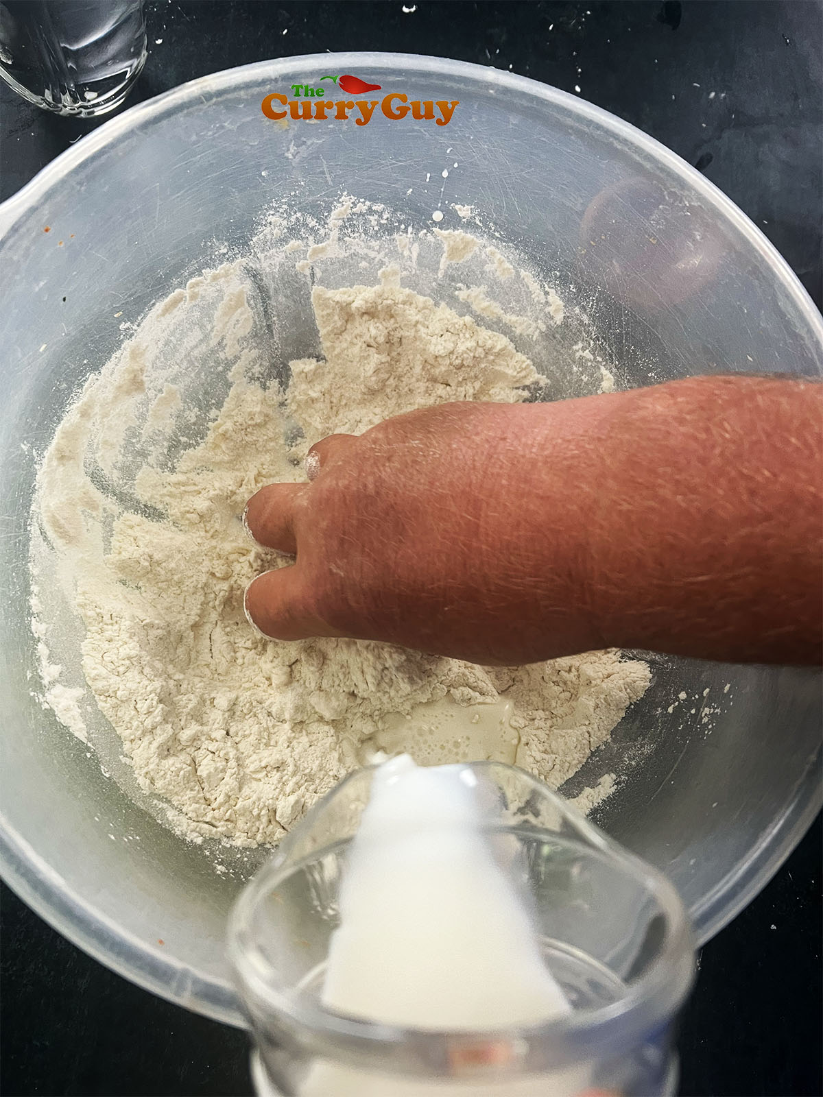Mixing the dough together in a mixing bowl.