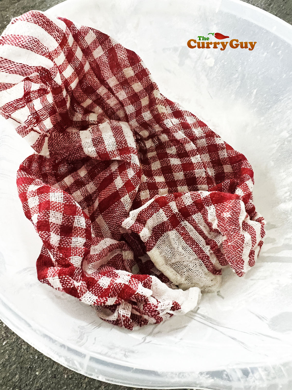 Dough ball resting under a damp cloth.