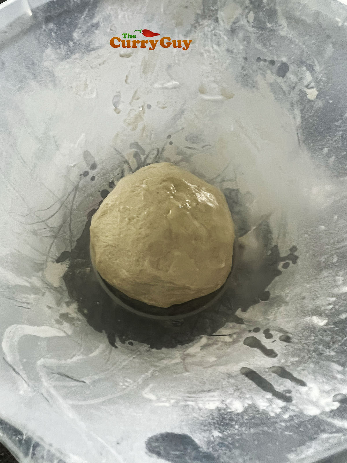 The dough ball rubbed with oil and in a mixing bowl. 