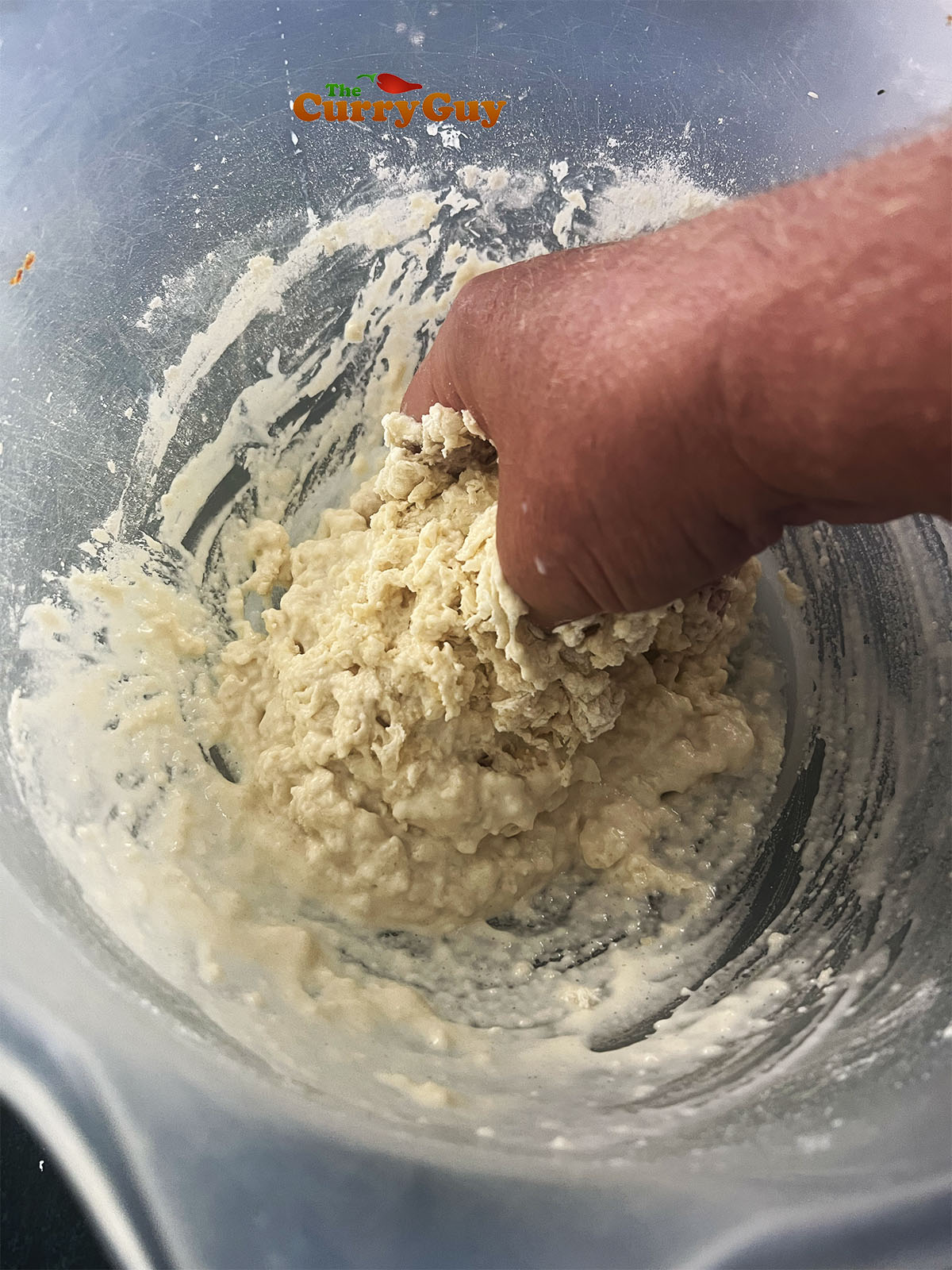 Kneading the dough together in a bowl.