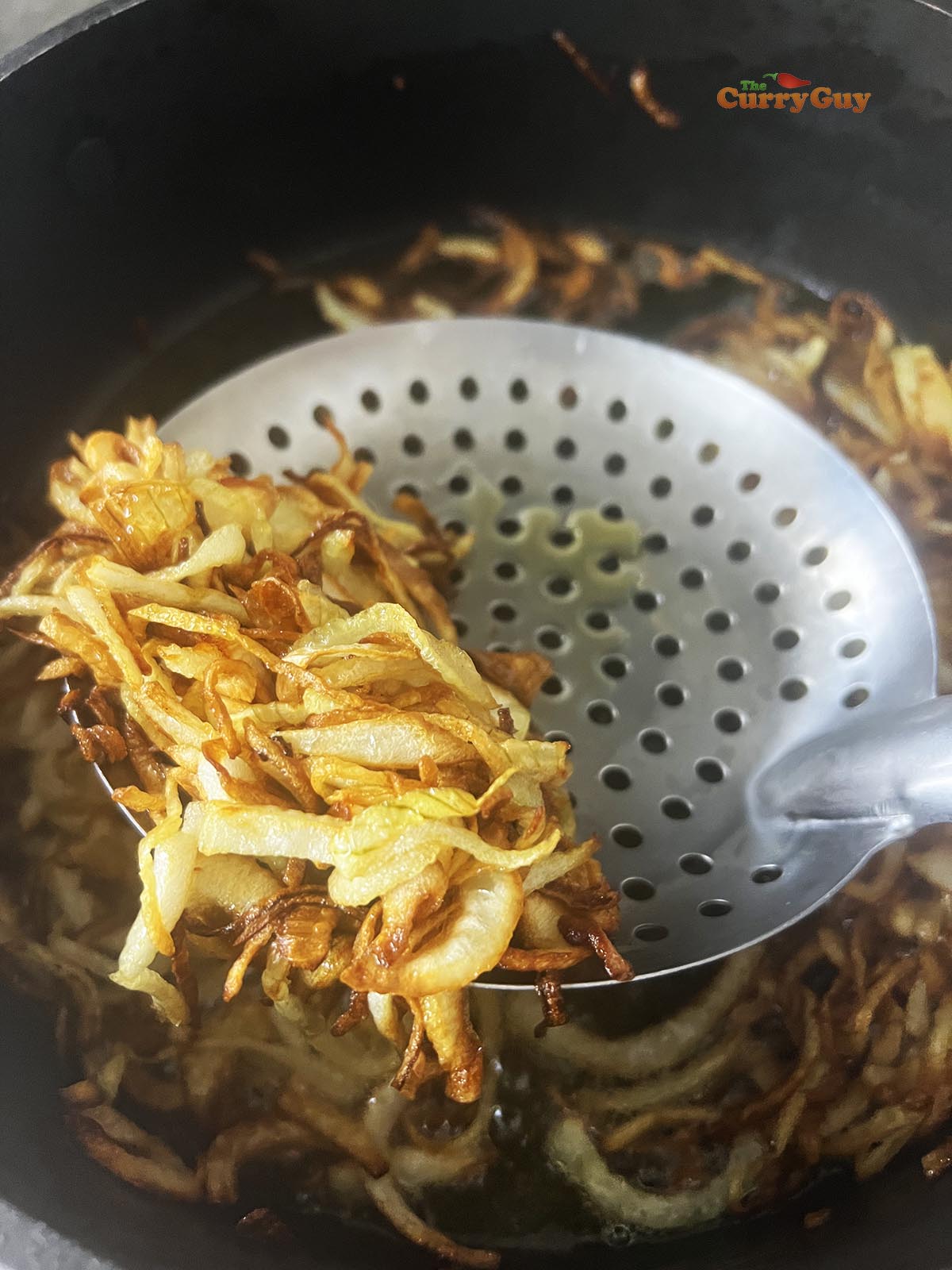 Frying onions in ghee.