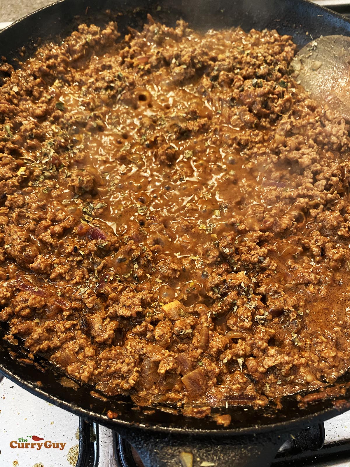 Simmering the keema meat in the pan.