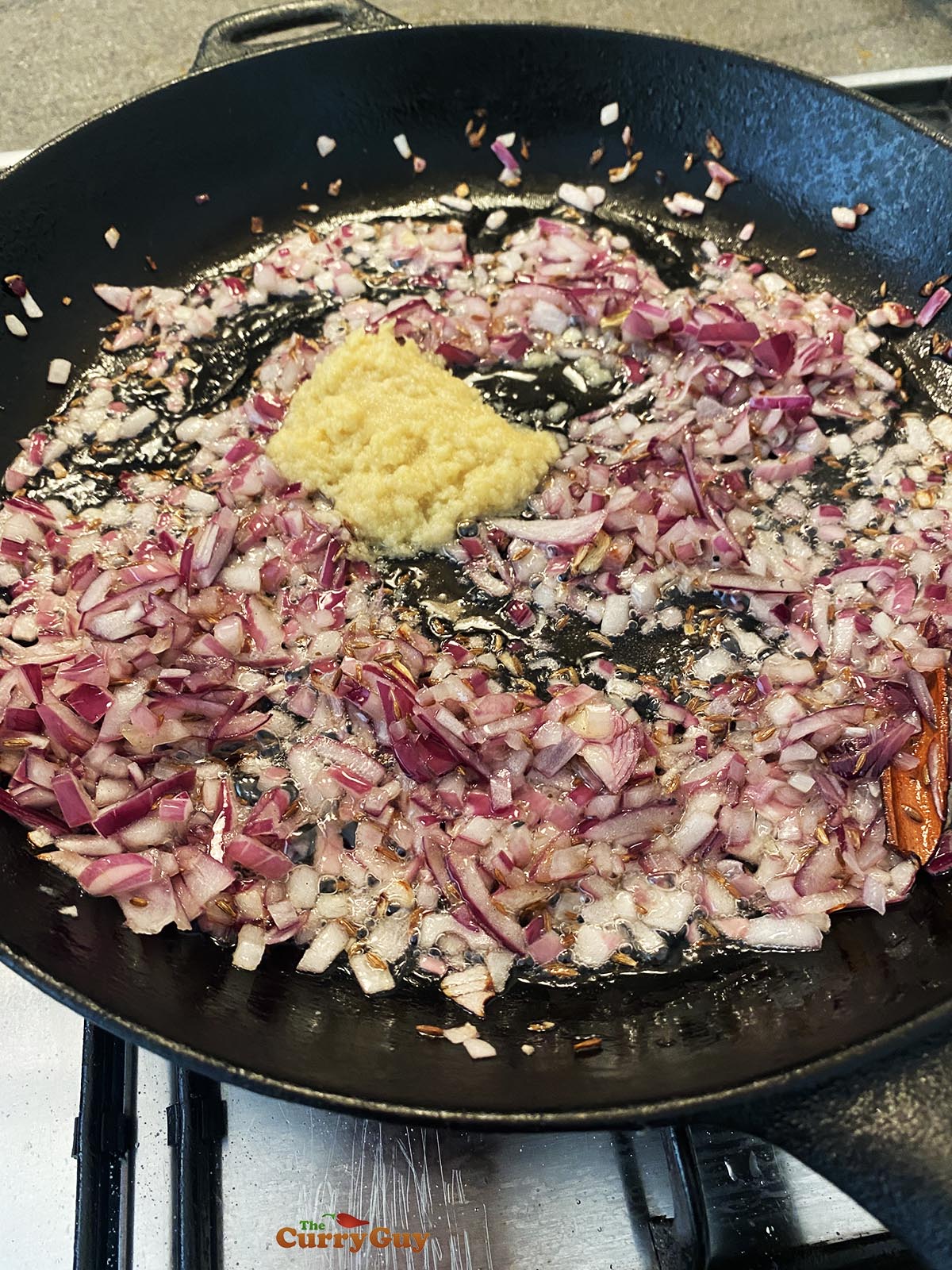 Frying the onions, garlic and ginger paste.