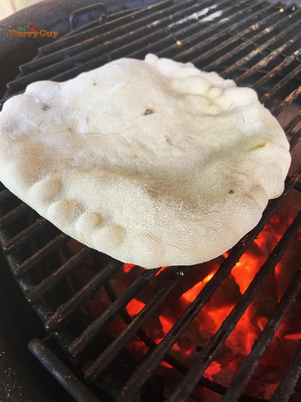 Kulcha cooking on a barbecue. 