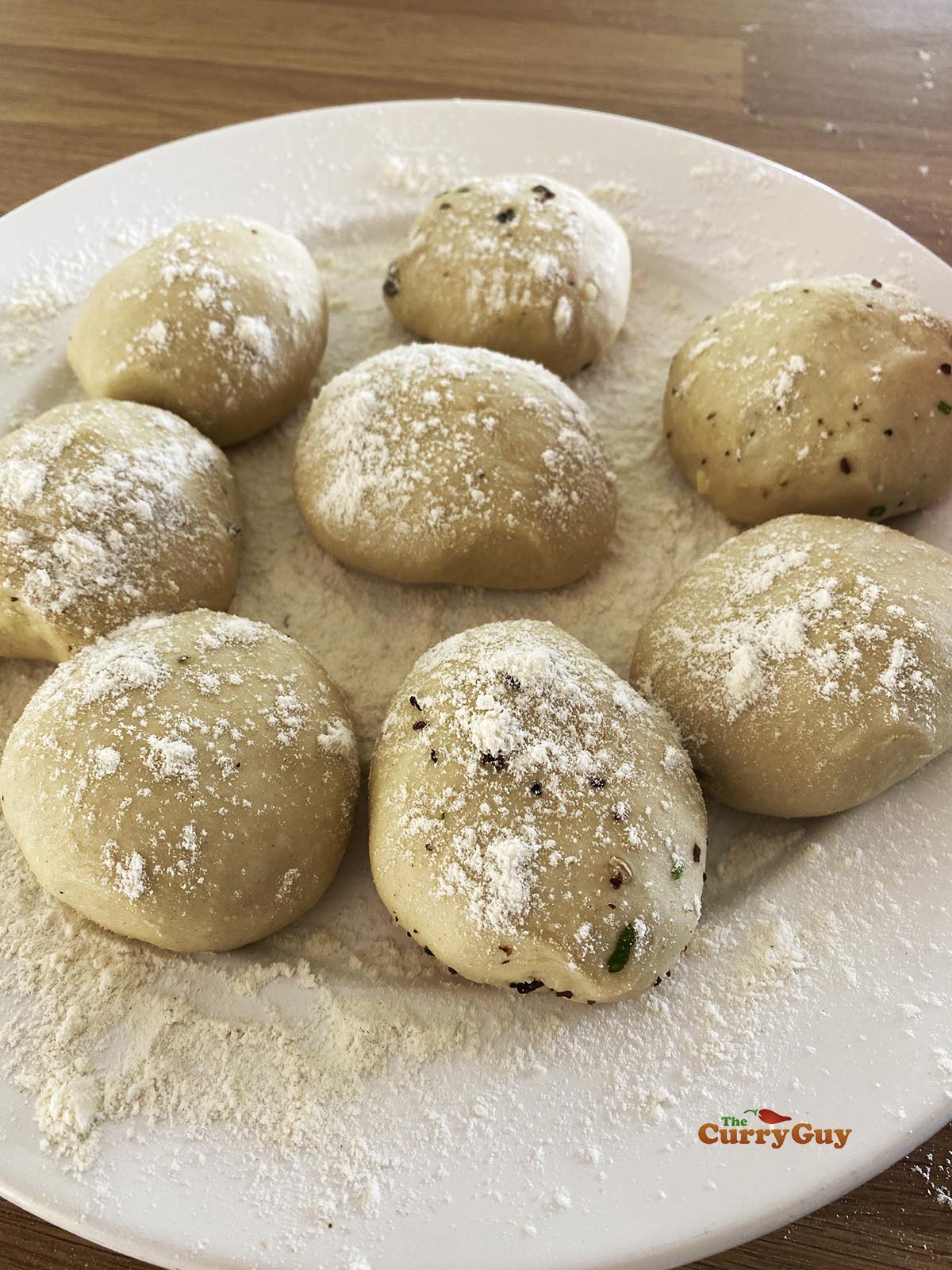 Forming the stuffed kulchas into balls.