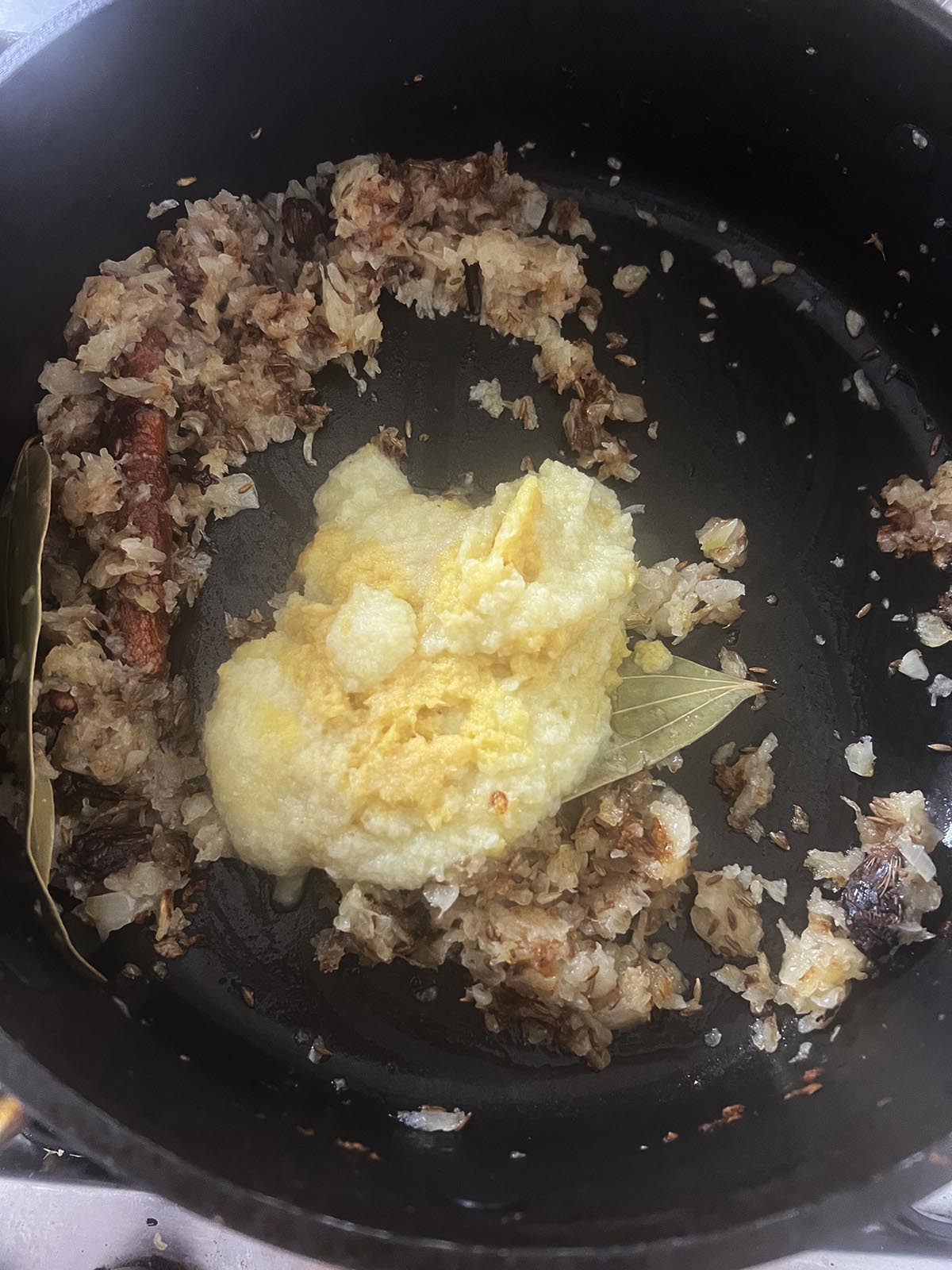 Frying the chopped onion and the garlic and ginger paste.