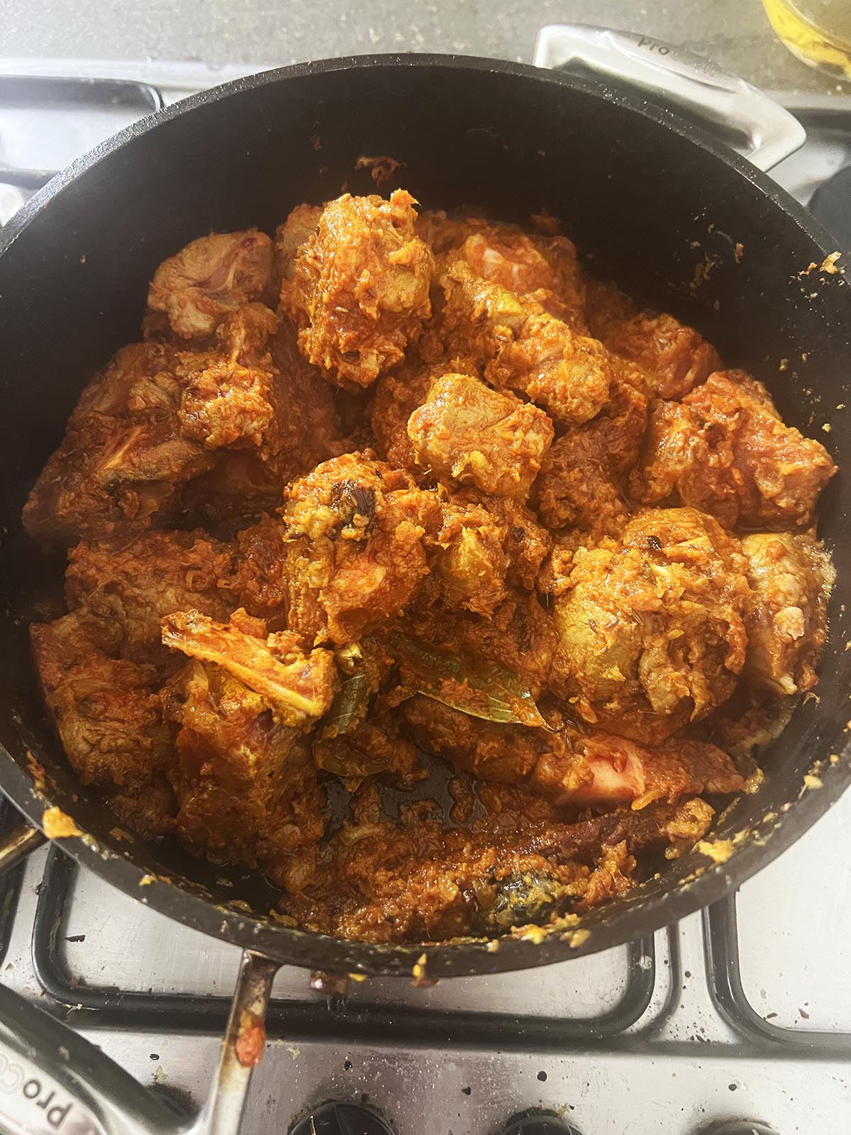 Frying the meat with the ground spices and onion mixture.