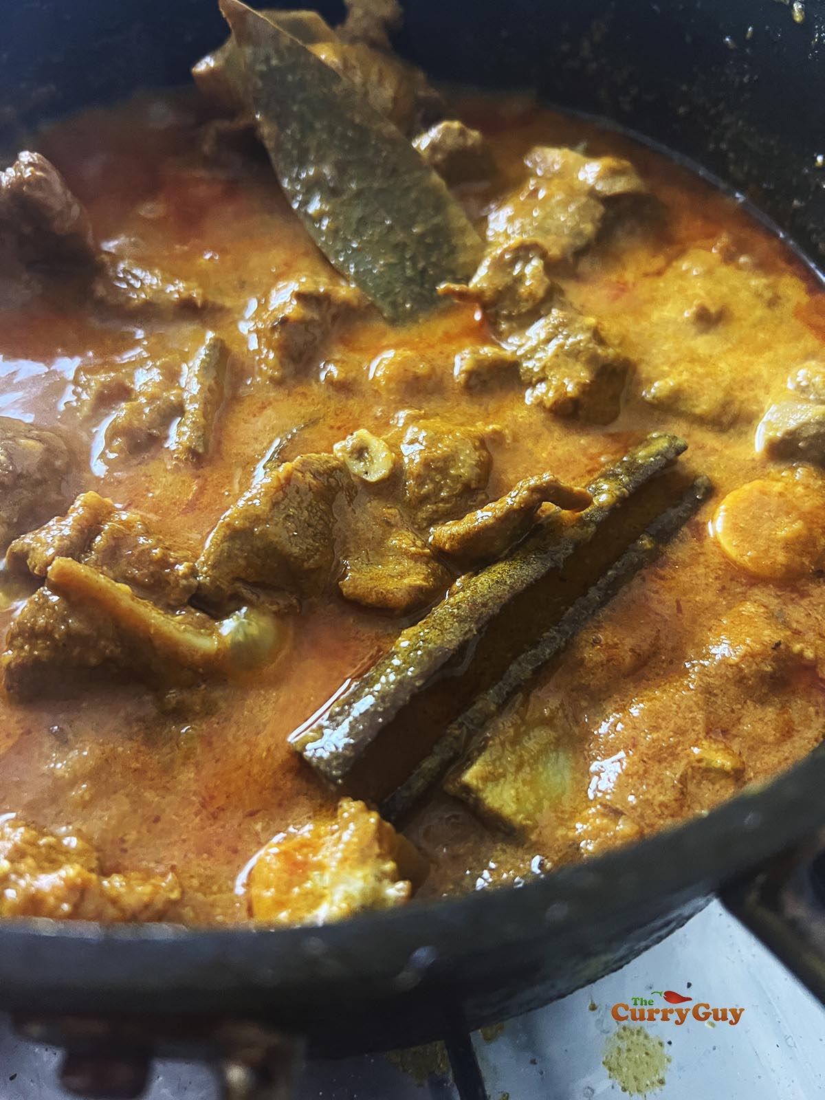 Simmering the curry to thicken.