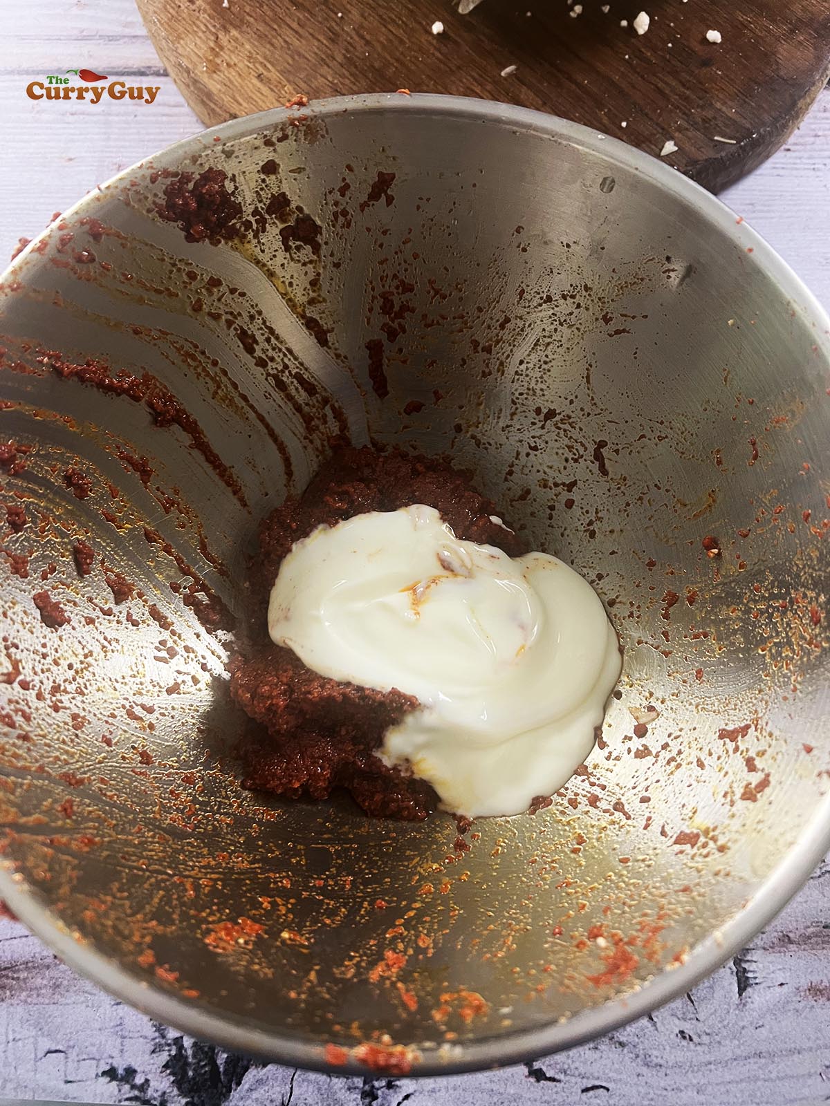 Tandoori masala paste and yoghurt in a mixing bowl.