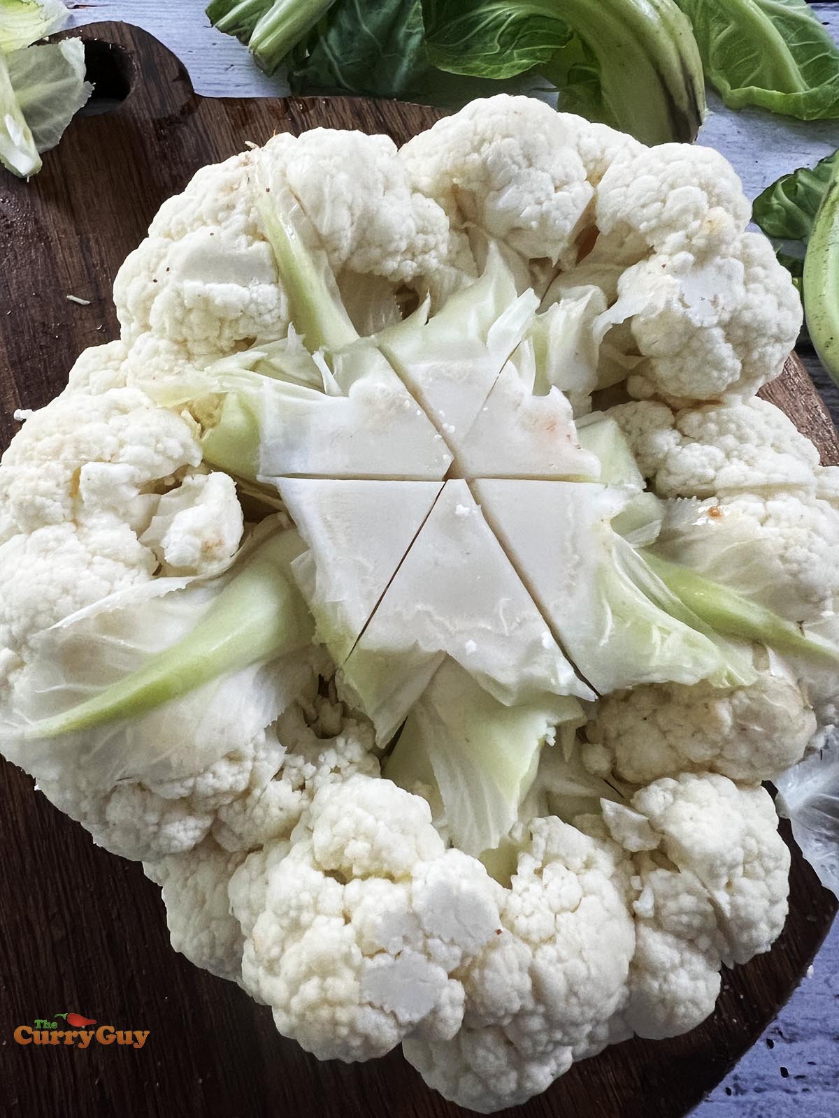 Making slices in the bottom of the cauliflower.