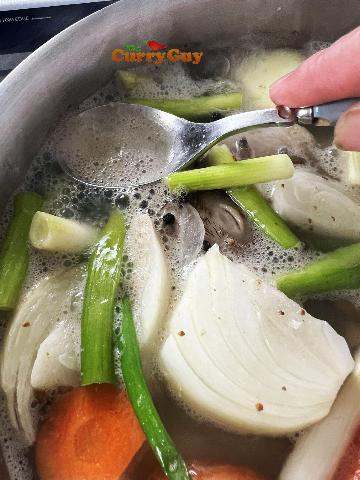 skimming foam off an Asian chicken stock.